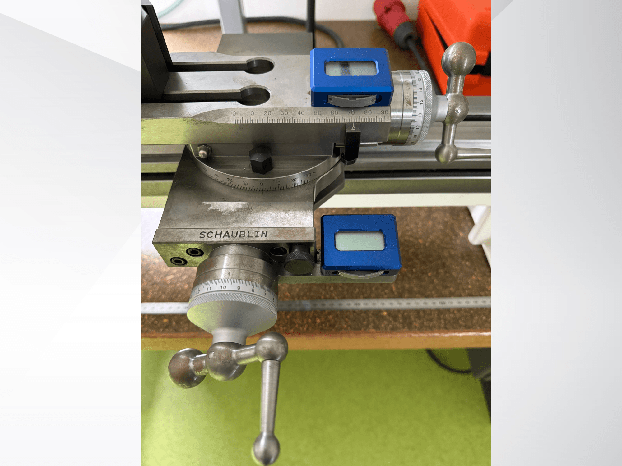 SCHAUBLIN 102Mi W25 horizontal turning machine controls, front view, featuring measuring dials and knobs on a metallic surface.