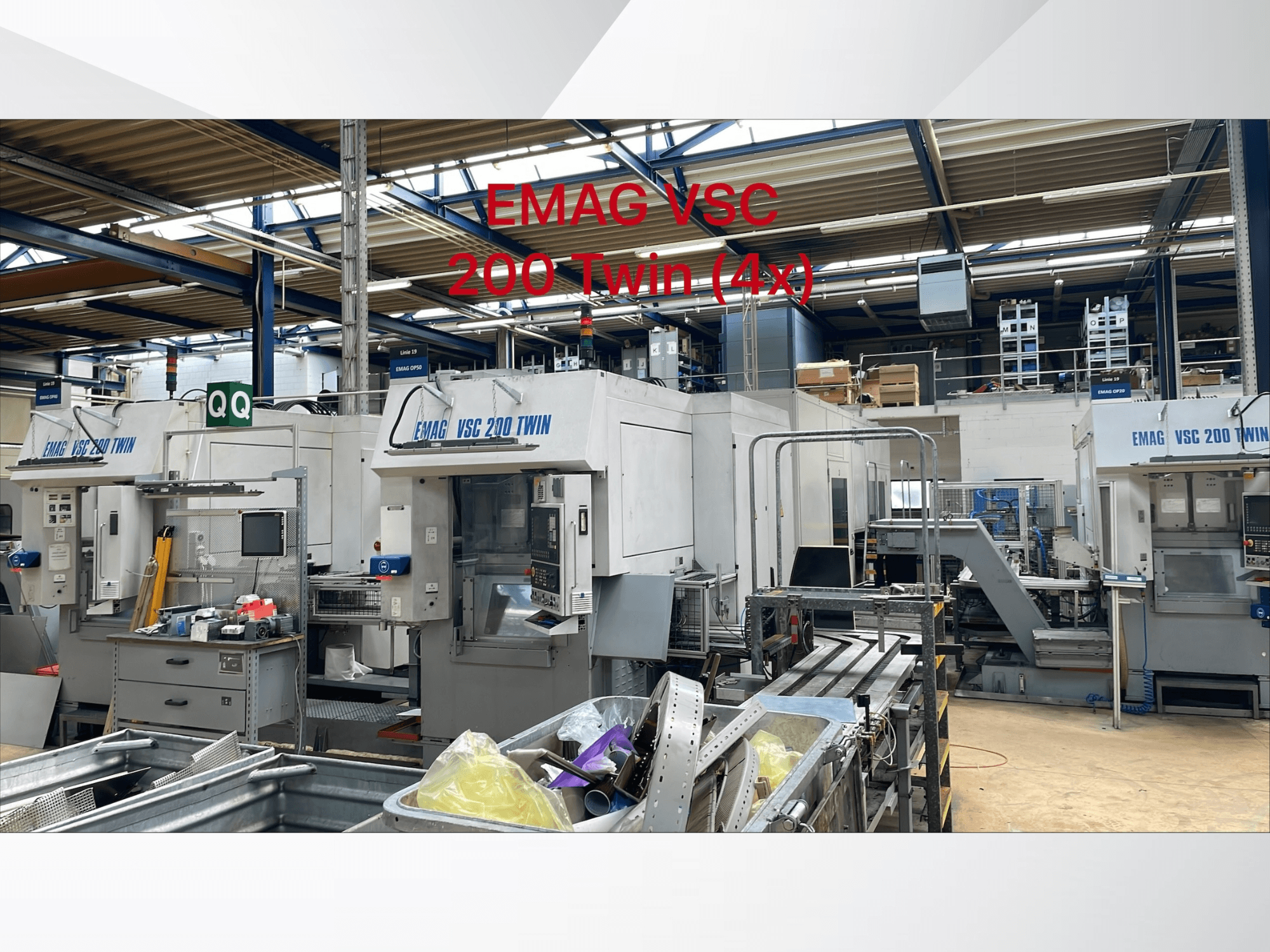 Front view of EMAG VSC 200 TWIN OP 20 vertical turning machines in a workshop, showcasing multiple units and surrounding equipment.