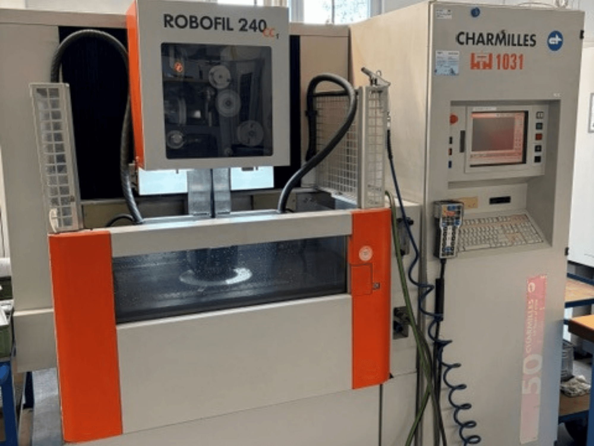 Charmilles Robofil 240 CC wire EDM machine, front view showcasing control panel and water reservoir area.