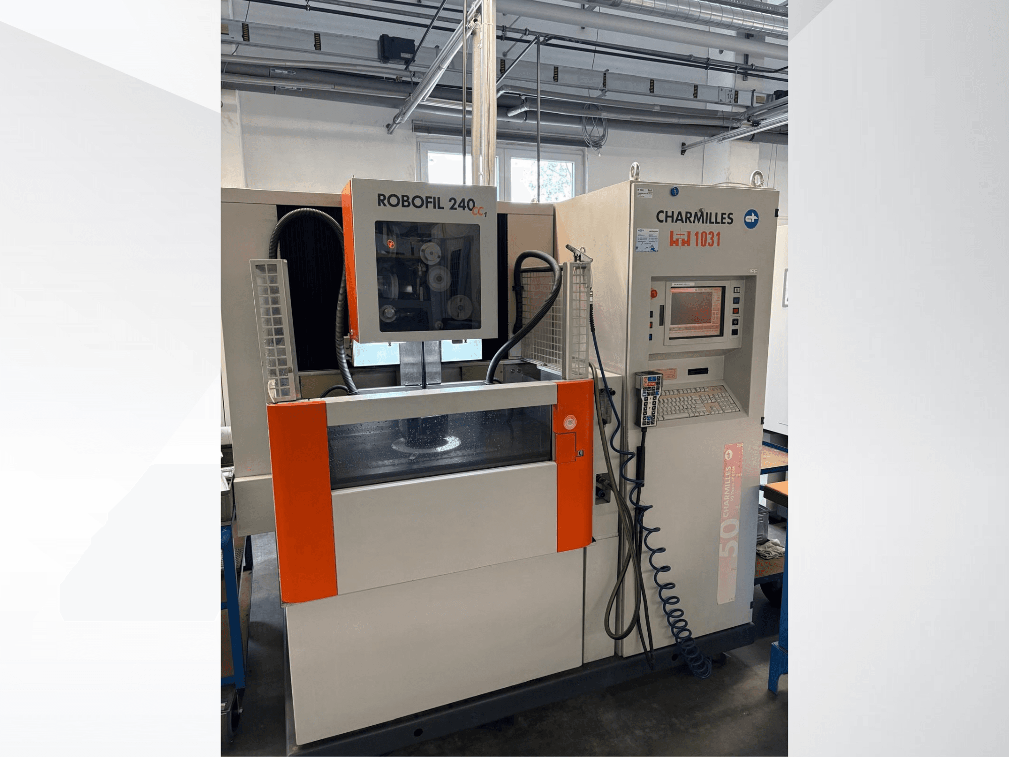 Wire EDM machine CHARMILLES Robofil 240 CC, front view showing control panel and water tank, with distinct orange accents.