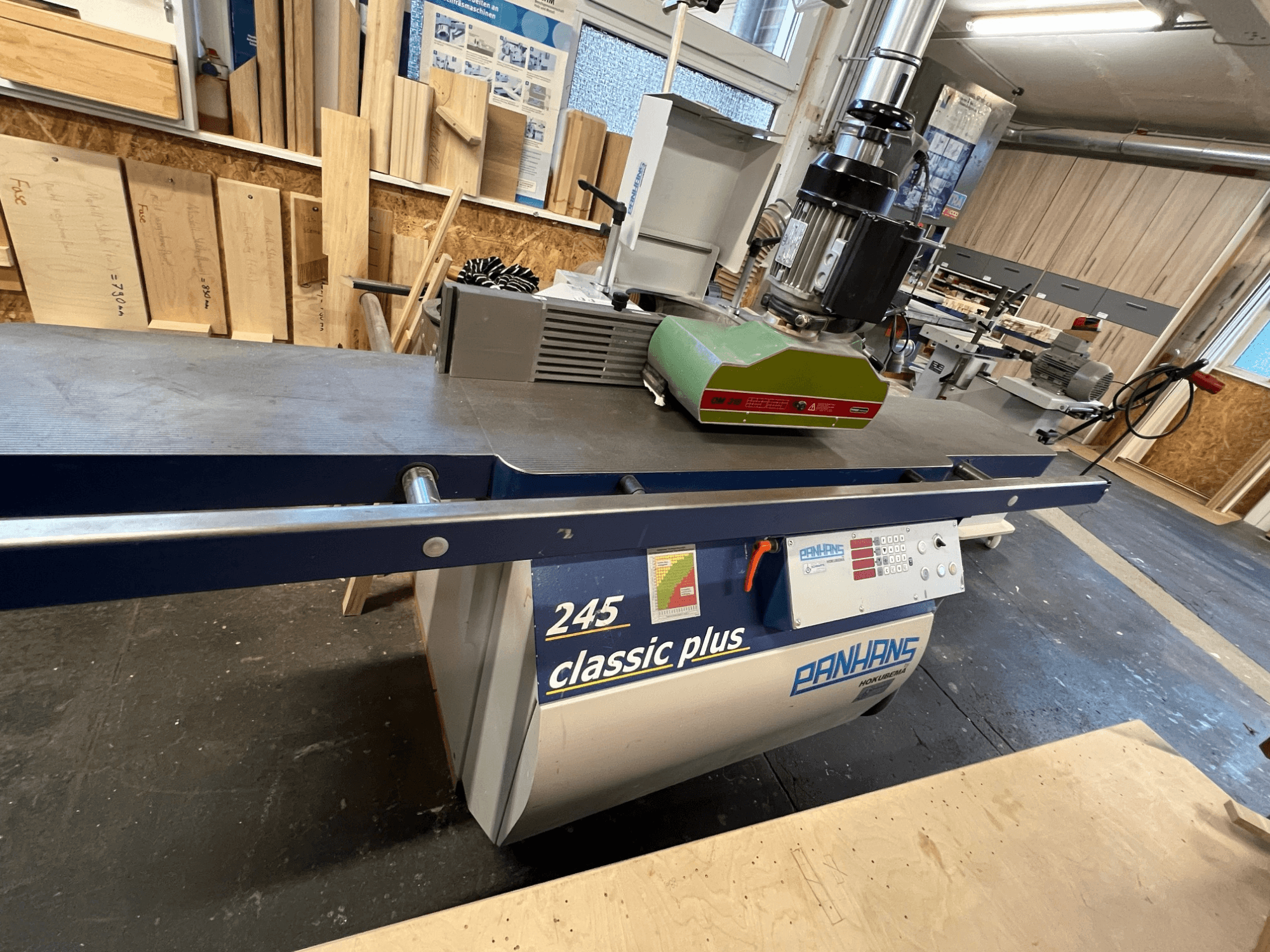 Spindle moulder PANHANS 245 classic plus, front view showcasing green motor, control panel, and work surface in workshop setting.