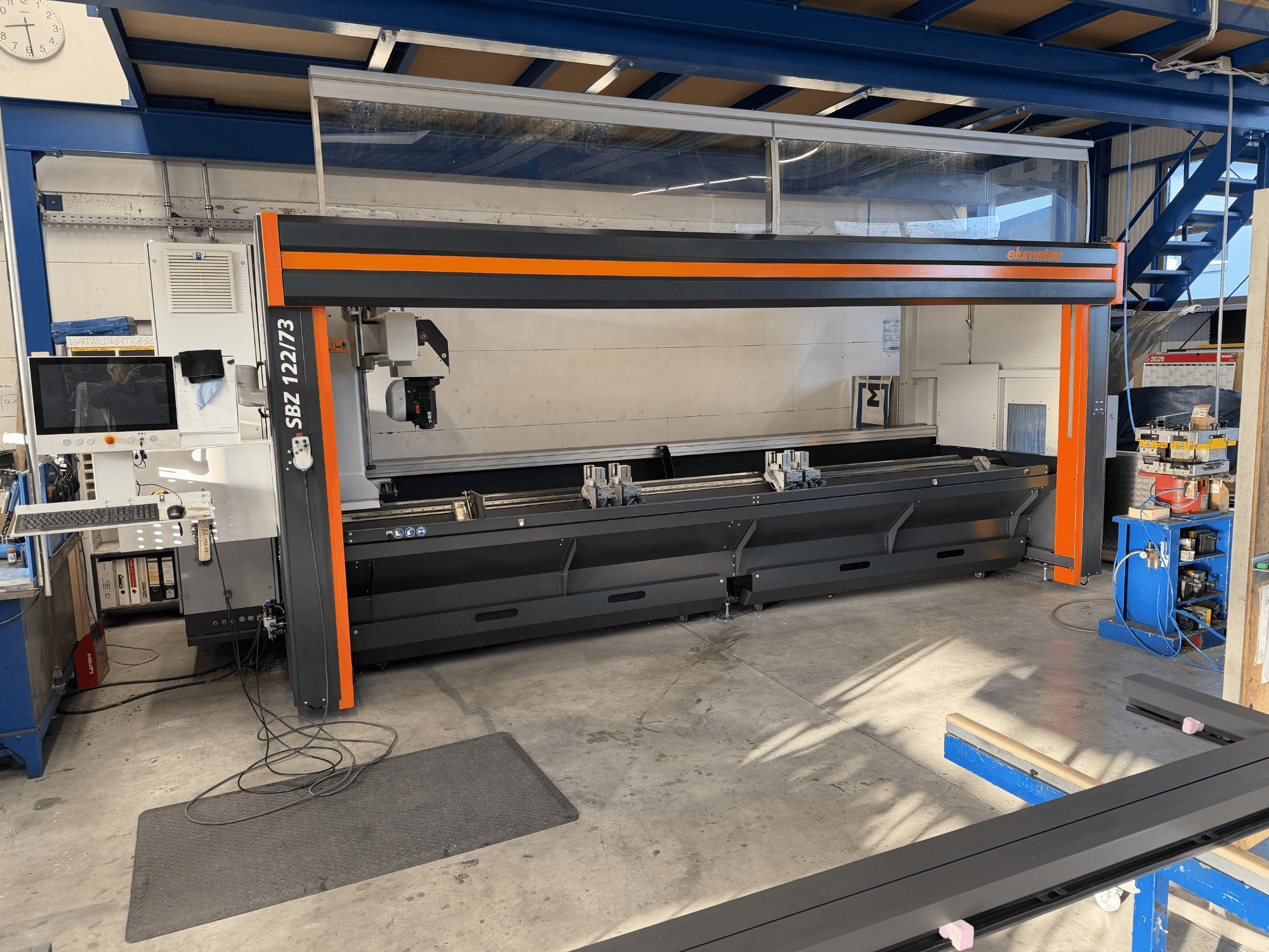 Elumatec SBZ 122/73 machine tool in front view, showcasing control panel, cutting area, and workspace layout.