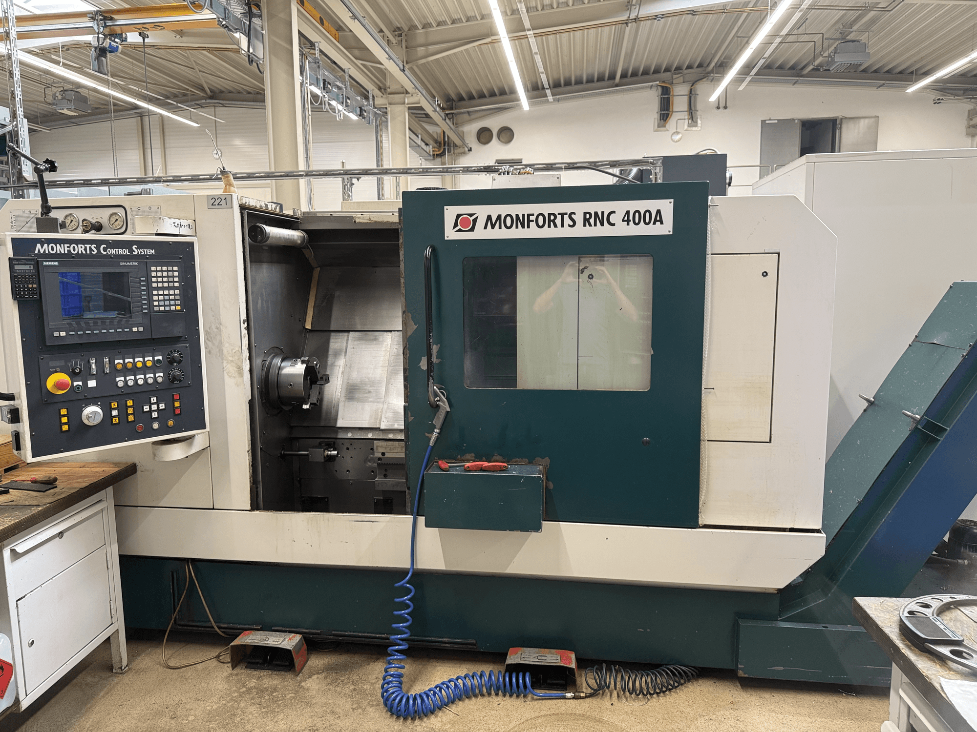 Monforts RNC 400 A Horizontal Turning Machine, front view, showcasing control panel and machine interior.