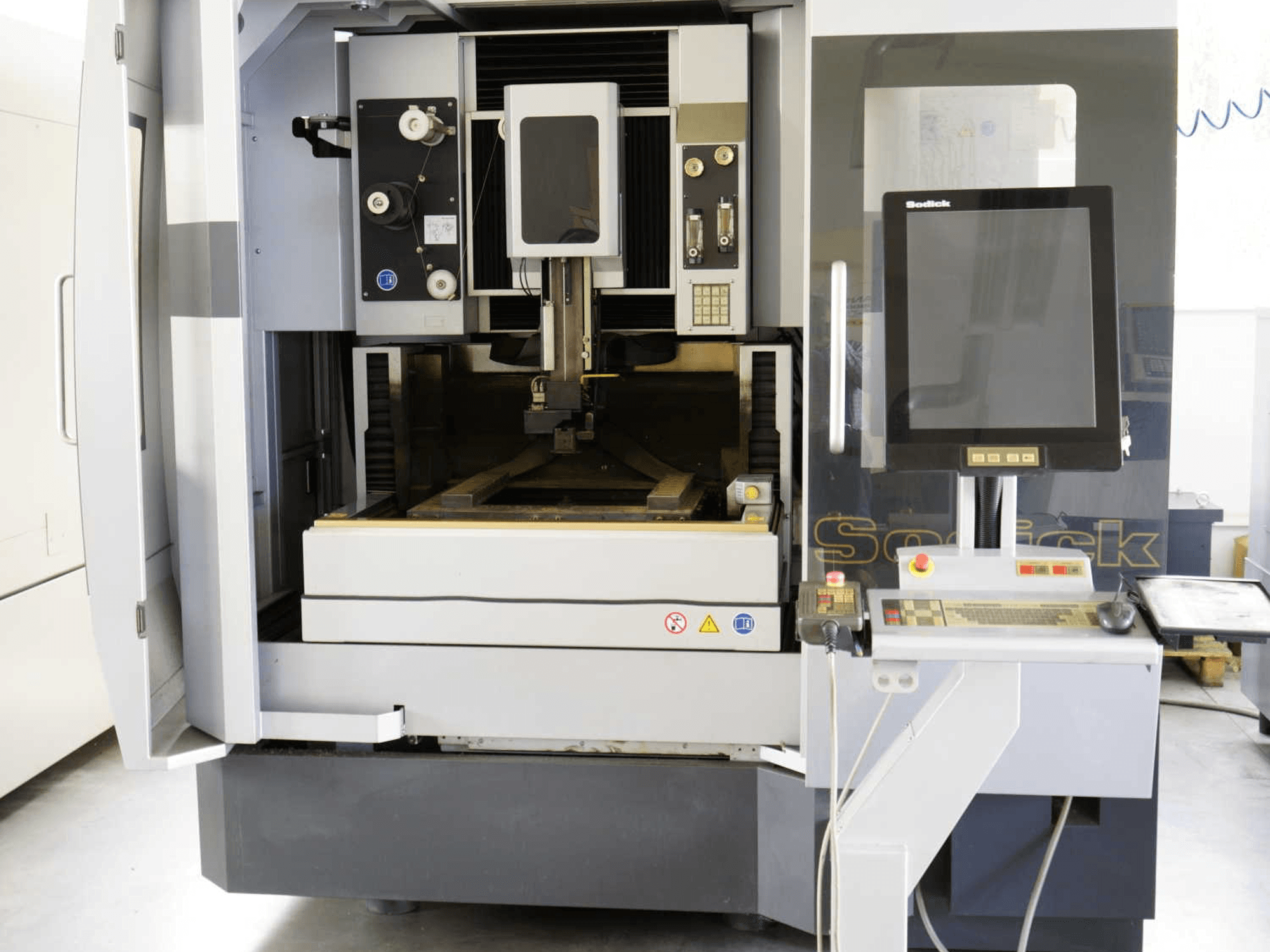 Sodick SLC400G Wire EDM Machine front view, featuring control panel, work area, and interior mechanisms clearly visible.