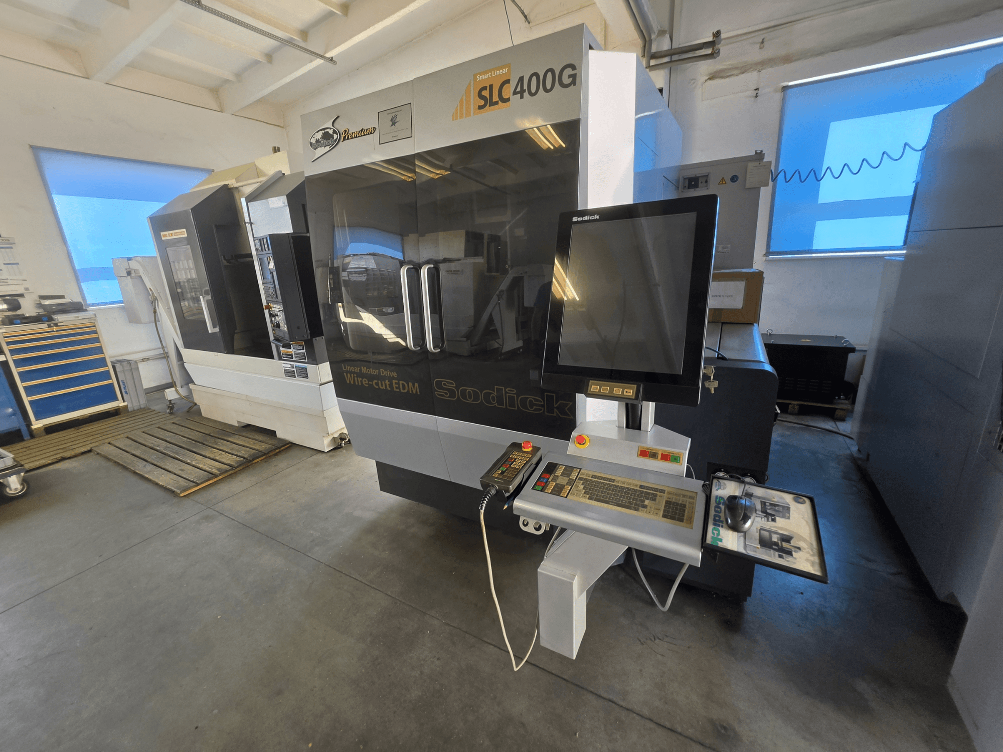 Sodick SLC400G Wire EDM machine, front view with control panel and touchscreen display in a workshop setting.