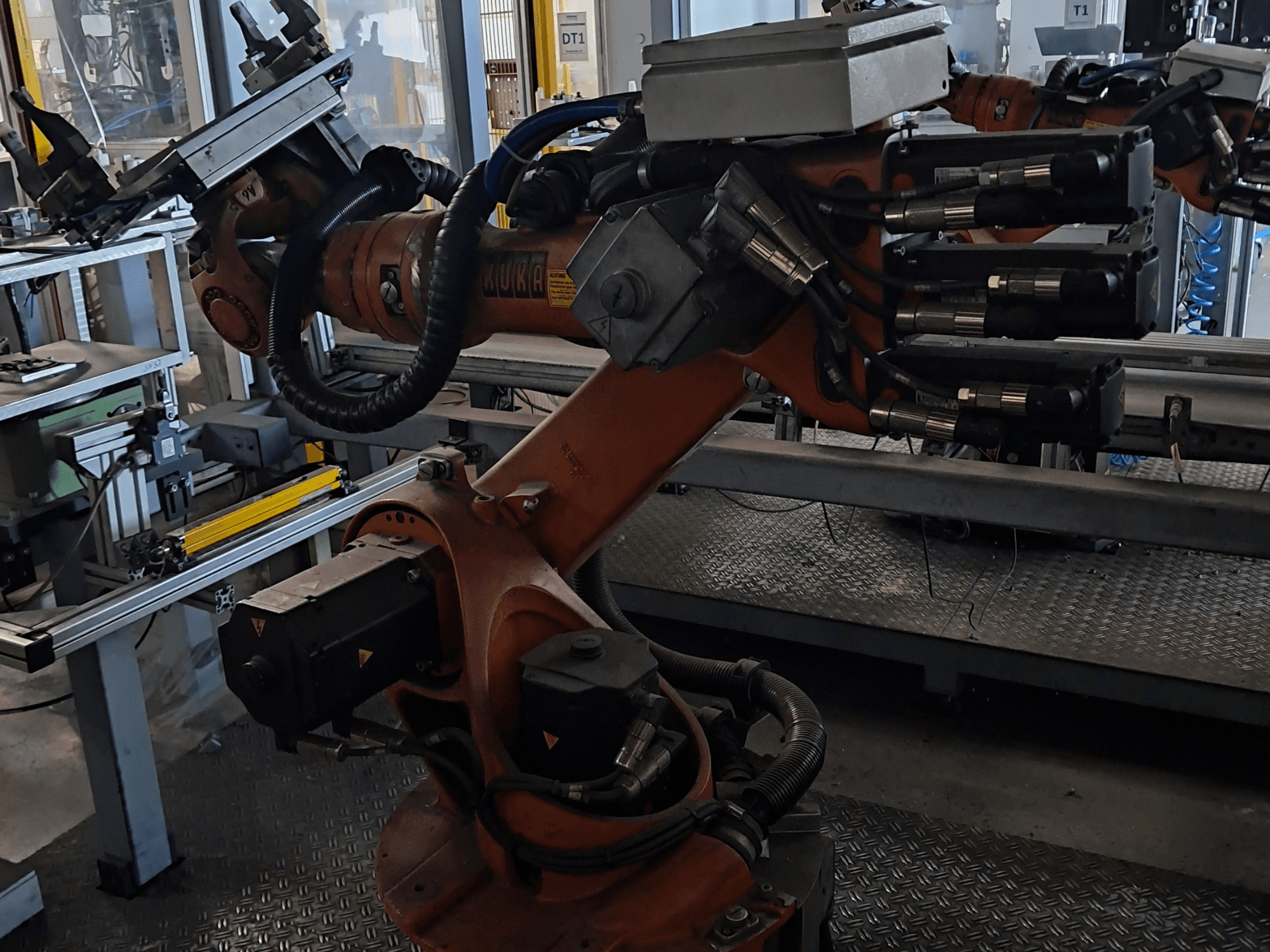 KUKA KR 16-2 Robot Arm with KRC 4 controller, side view showcasing joints, cables, and tool attachment.