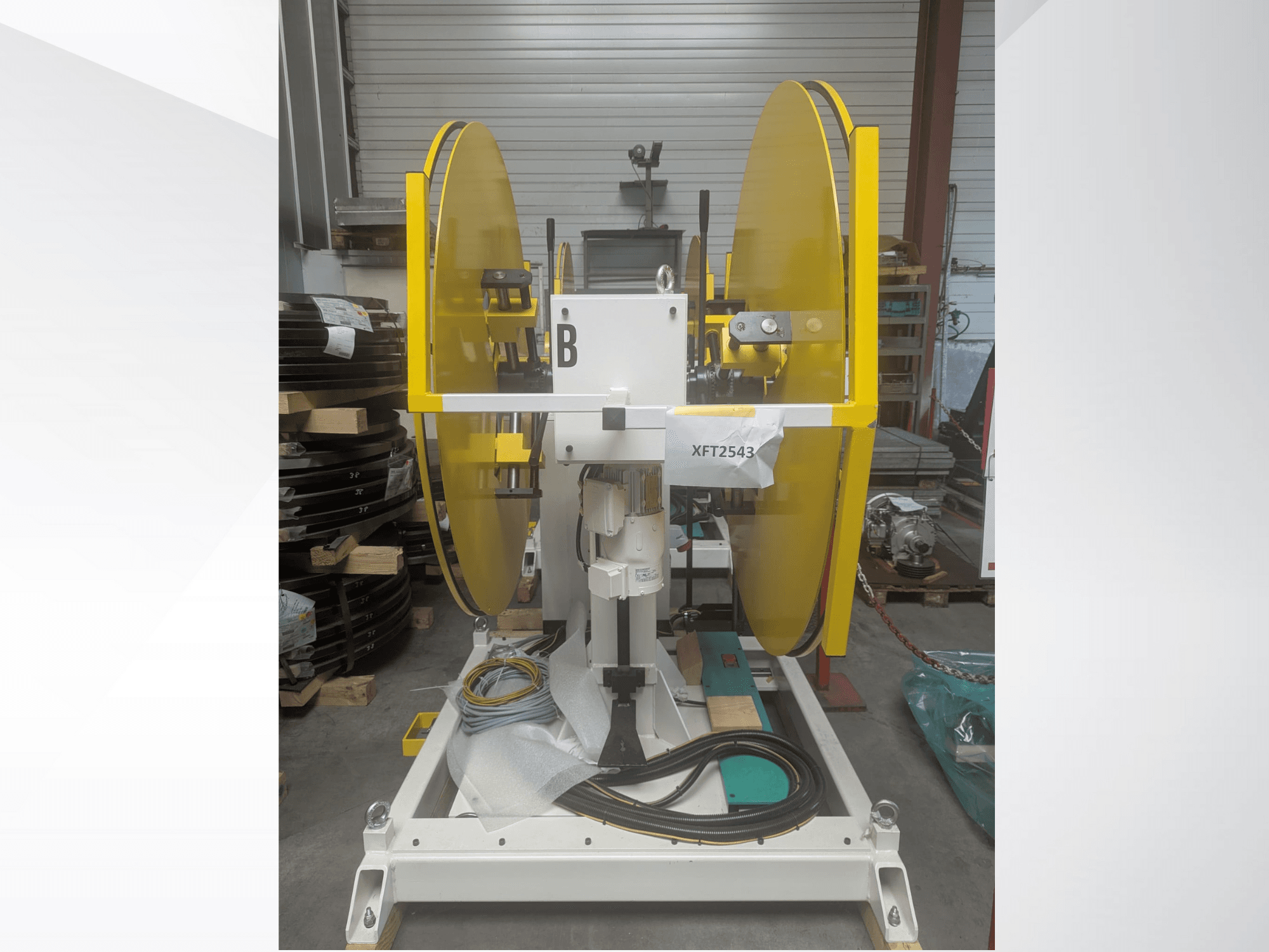 Yellow circular saw blades mounted on a white machine base, front view; model XFT2543, with visible wiring and components.