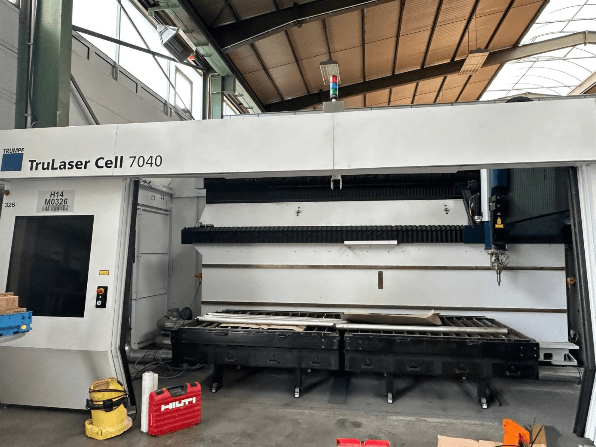TRUMPF TruLaser Cell 7040 CO2 laser cutting machine in front view, showcasing control panel and cutting area.