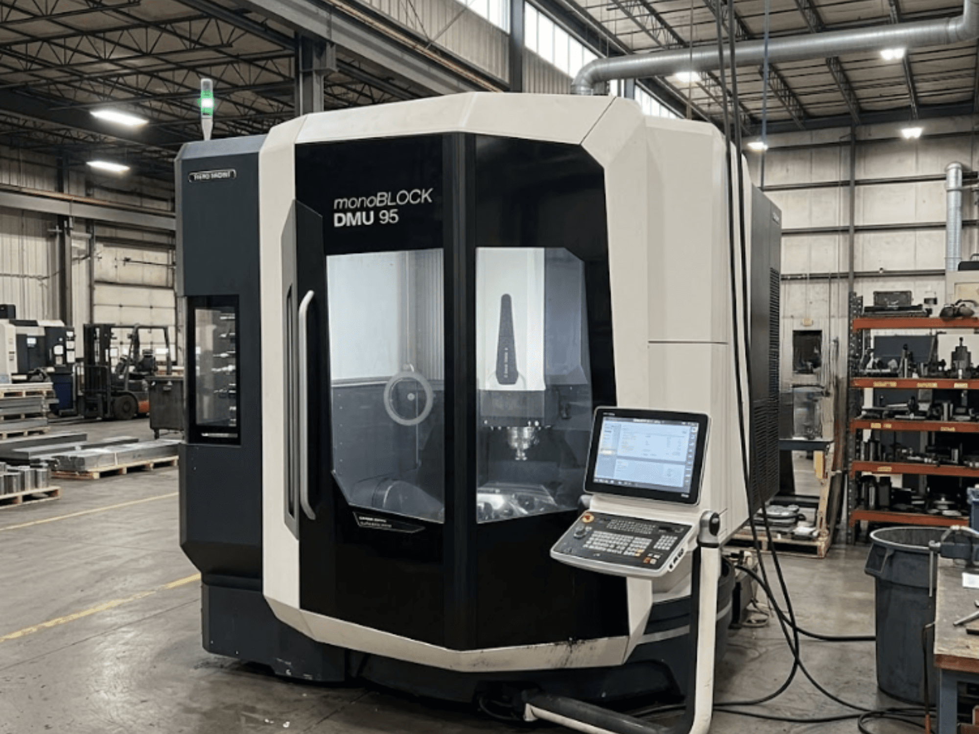 Vertical machining center DMG MORI DMU 95 Monoblock in a factory with control panel visible, front view.