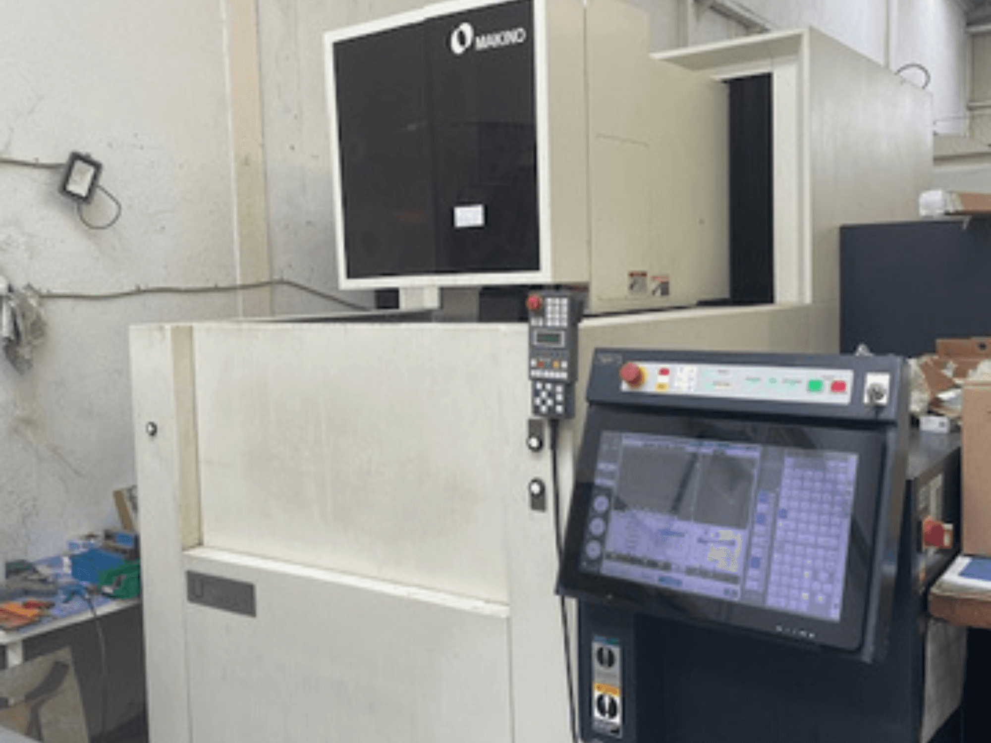 Makino U6 HEAT wire EDM machine in a workshop, front view showing control panel and digital display.