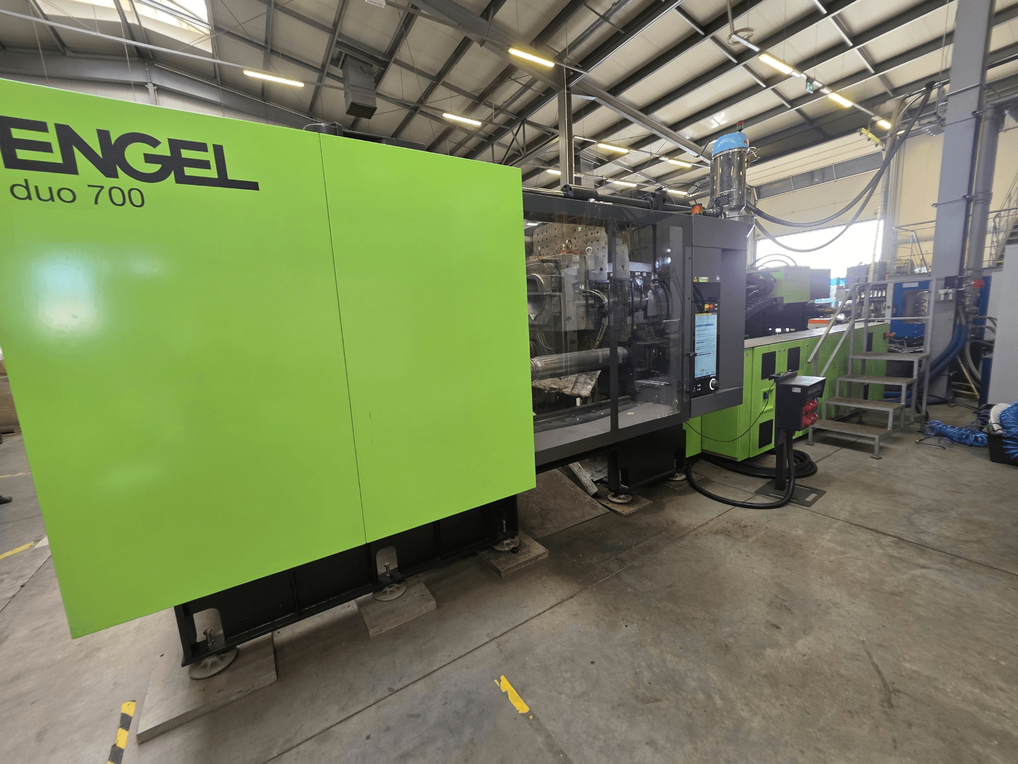Engel duo 700 hydraulic injection moulding machine, front view, showing green exterior and control panel.