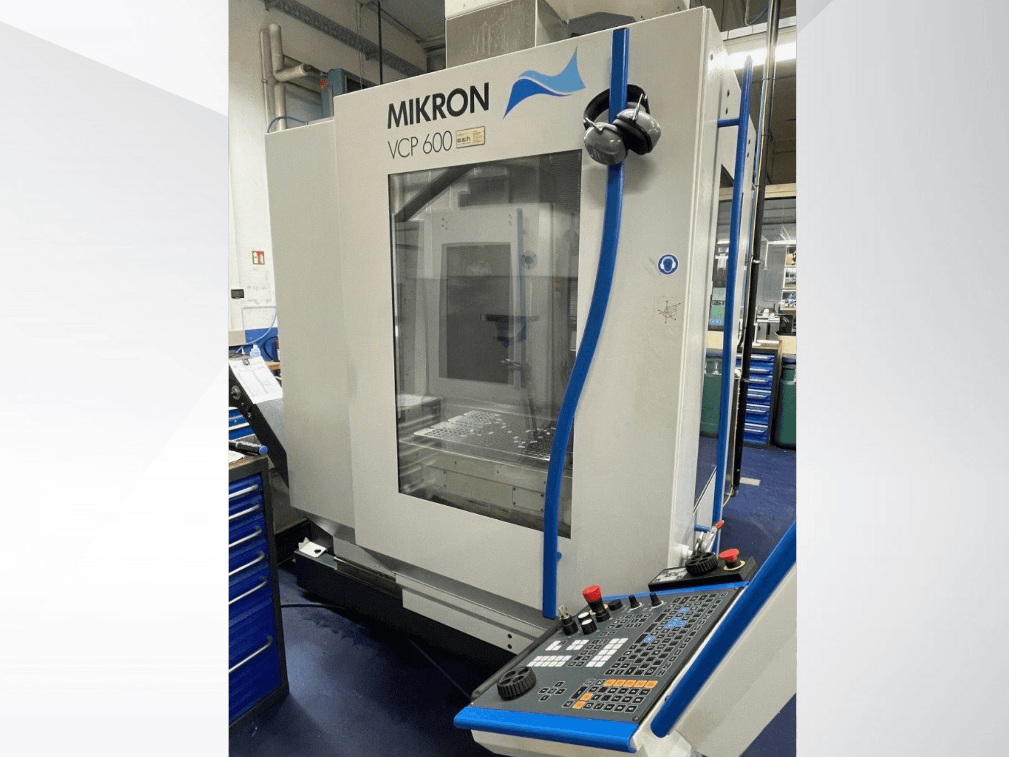 Mikron VCP 600 machining center in a workshop, front view, with a control panel featuring buttons and knobs.