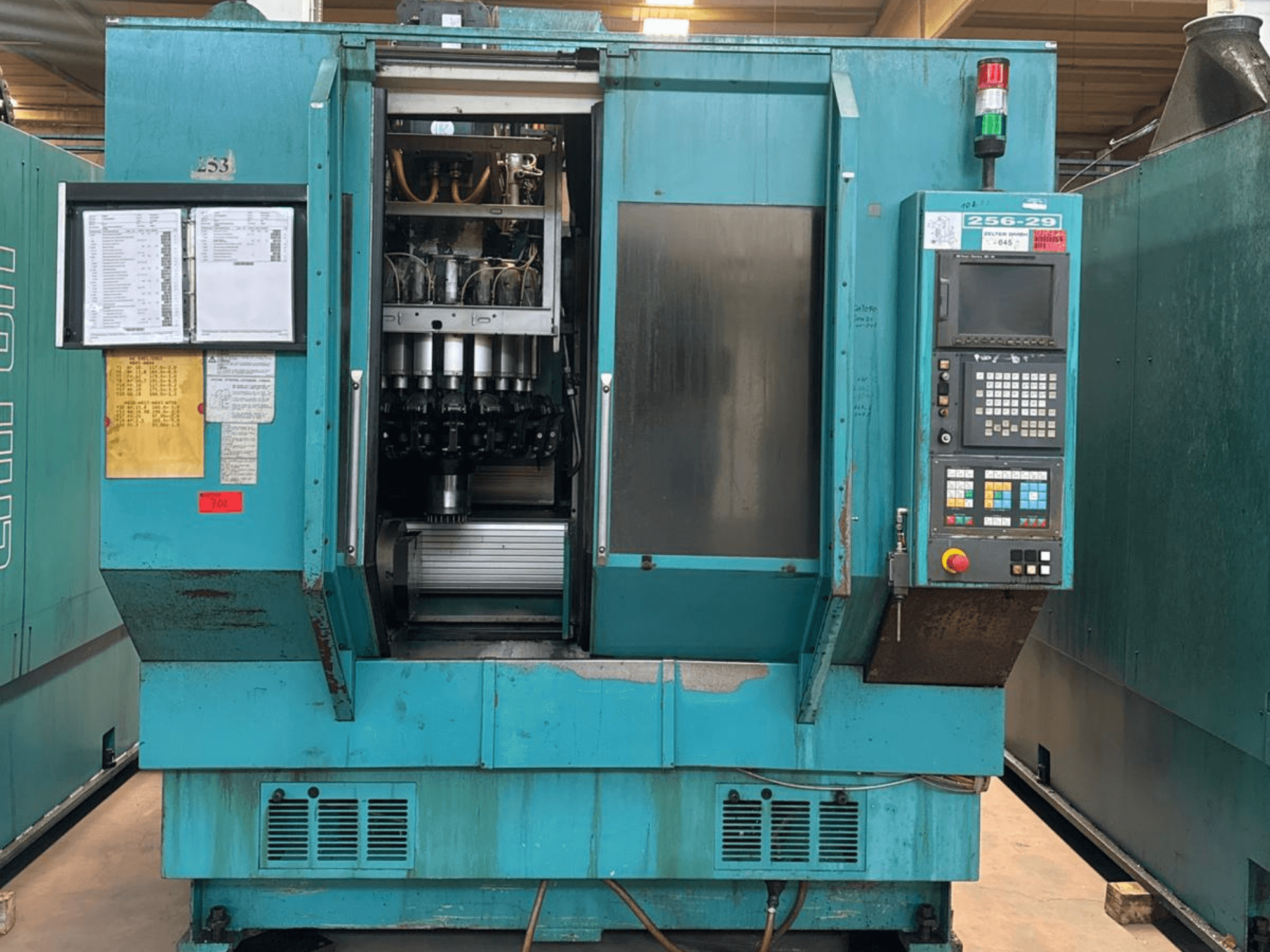 Front view of CHIRON FZ 18 S LEAN vertical machining centre, showing control panel, tool holder, and operational instructions.