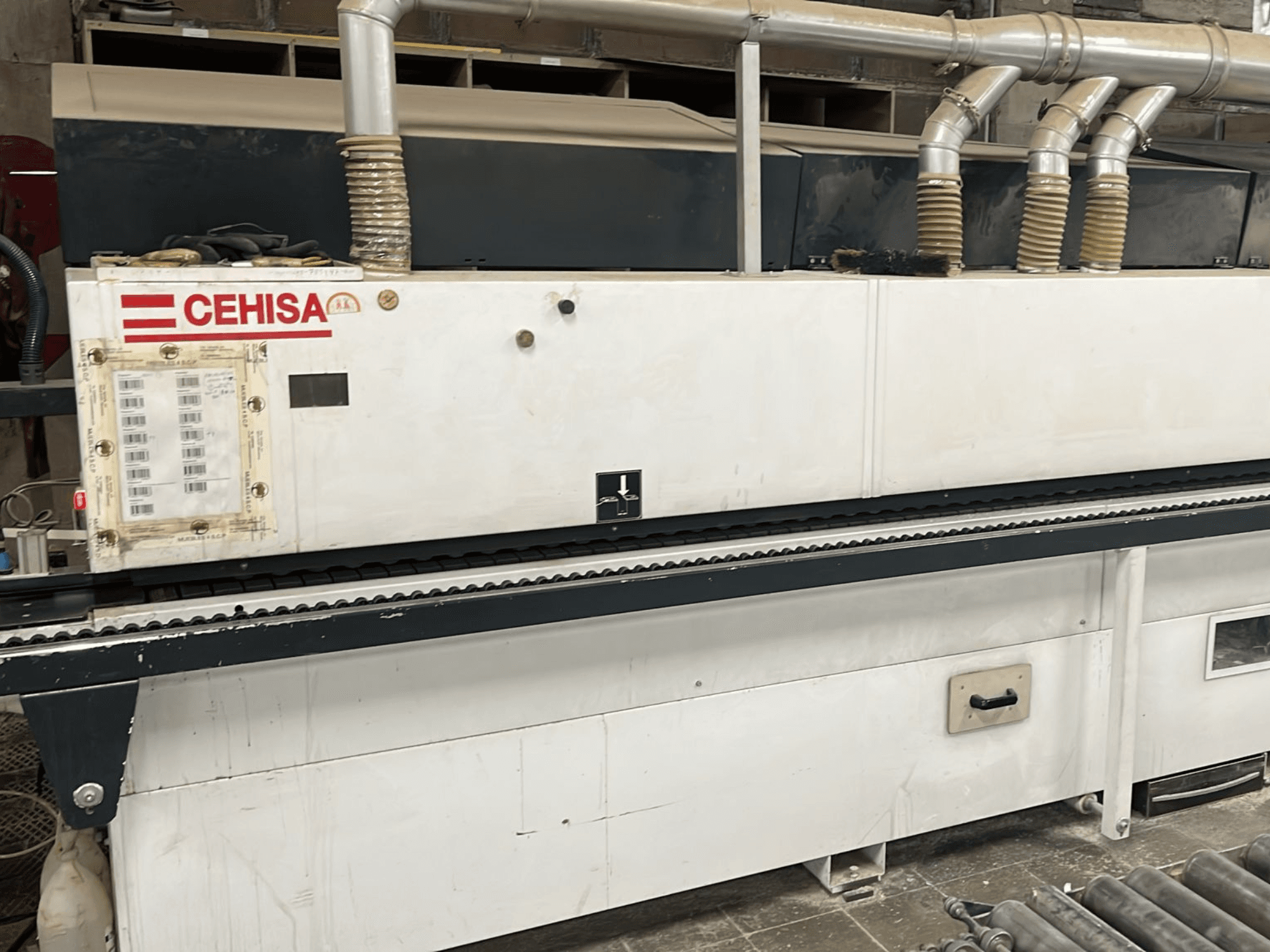 CEHISA PRO 12 CONCEPT edgebander in a front view, featuring control panel, dust extraction tubes, and conveyor belt.