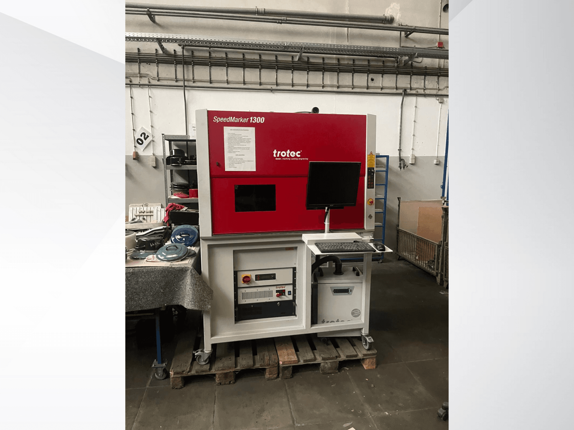 Trotec SpeedMarker 1300 laser engraving machine, front view, with monitor, keyboard, and technical controls visible.