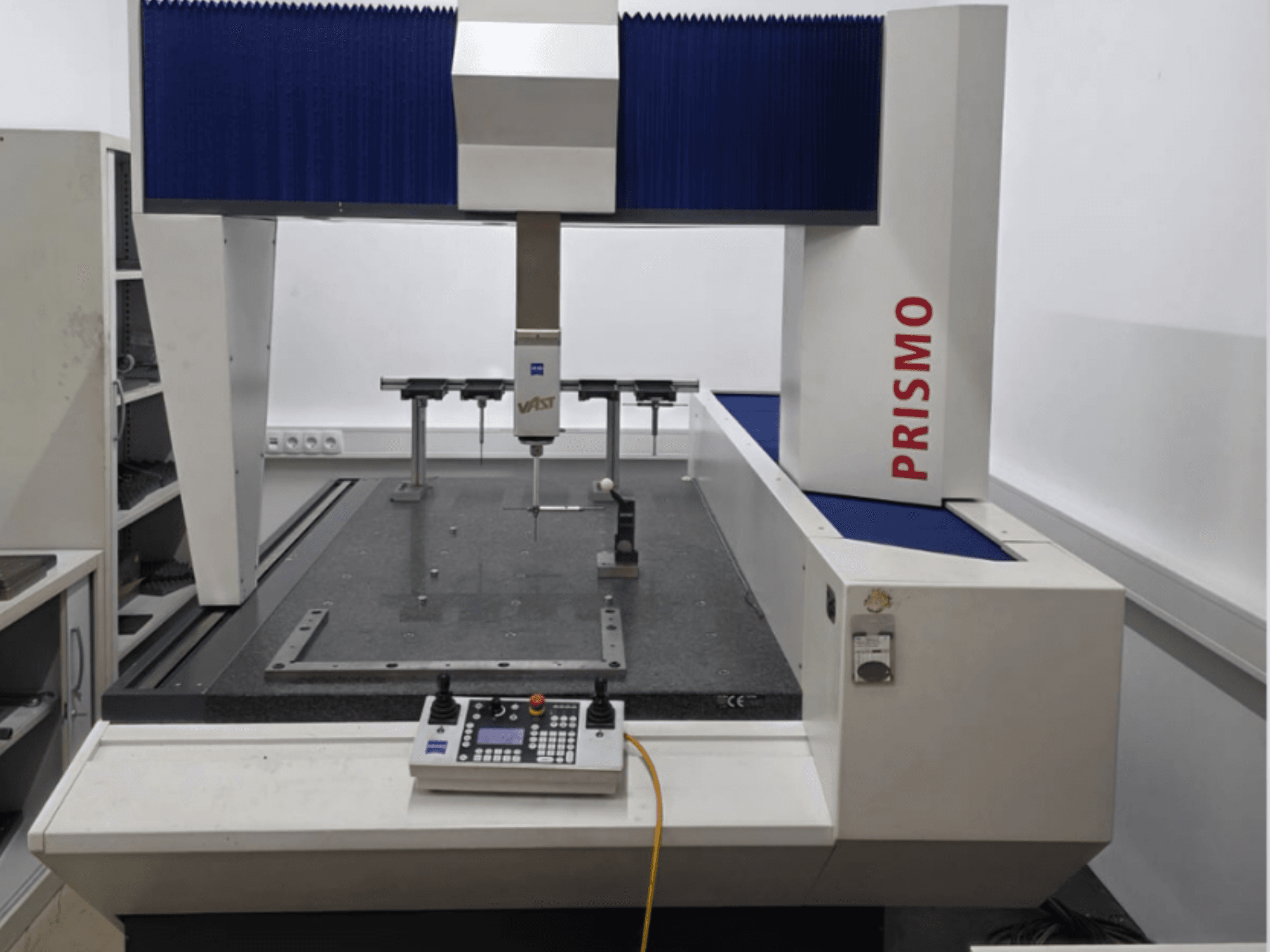 ZEISS PRISMO 700 Coordinate Measuring Machine in front view, featuring a probe and control panel on a granite base.
