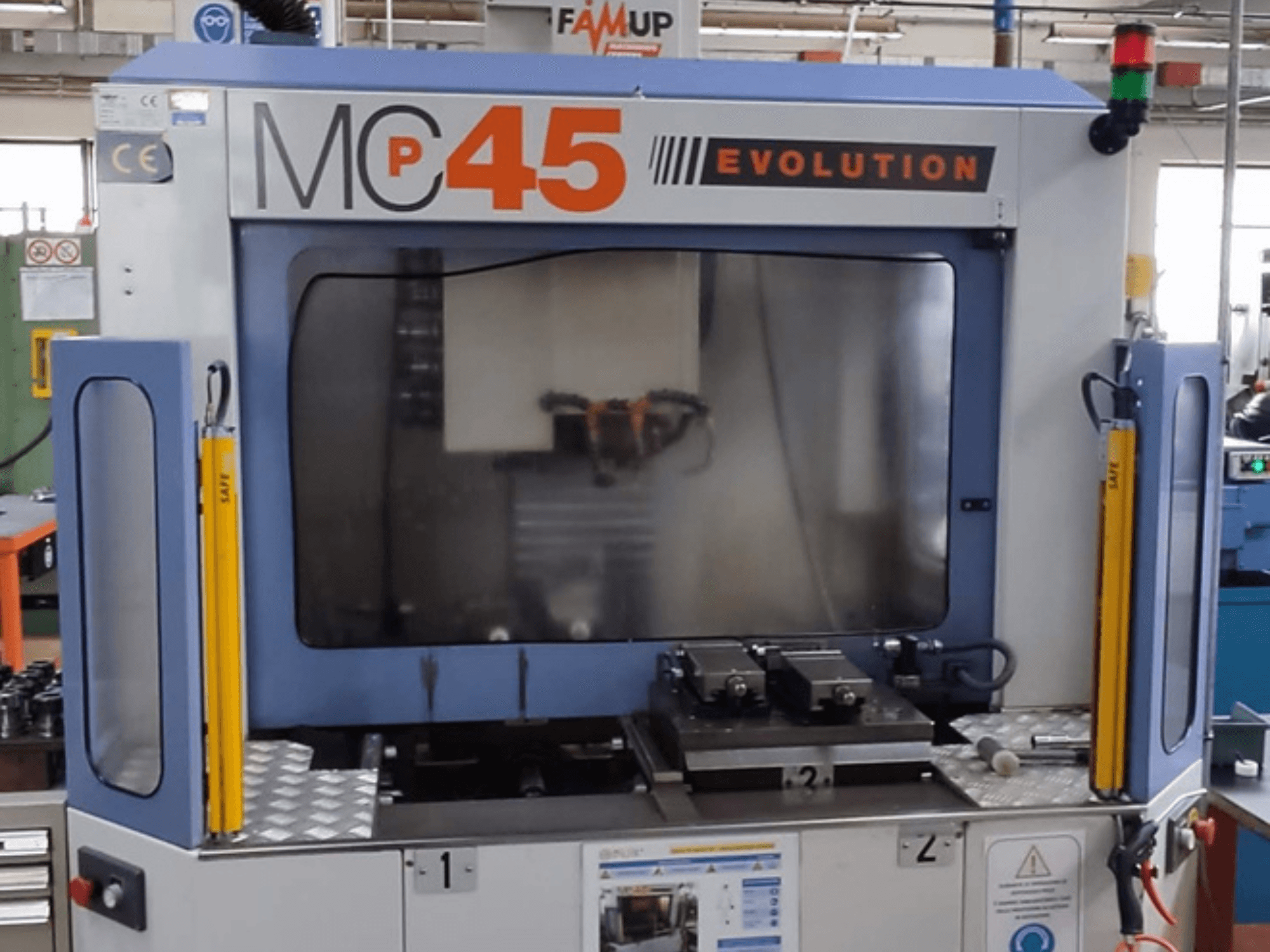FAMUP MCP 45 E vertical machining centre in front view, showcasing operational controls and milling work area.