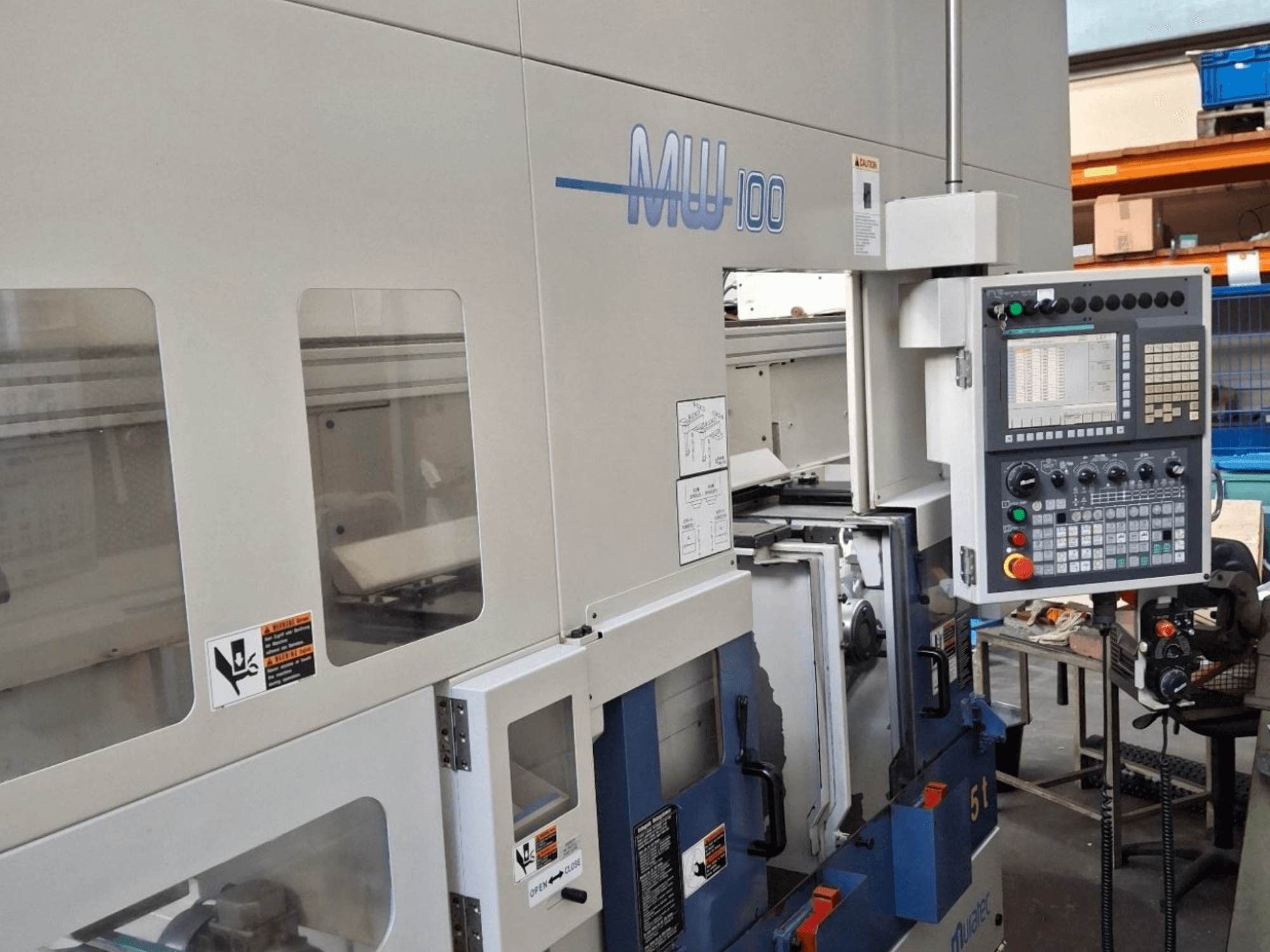 Muratec MW 100 GT multi-spindle turning machine, front view, showcasing control panel and machine compartments.