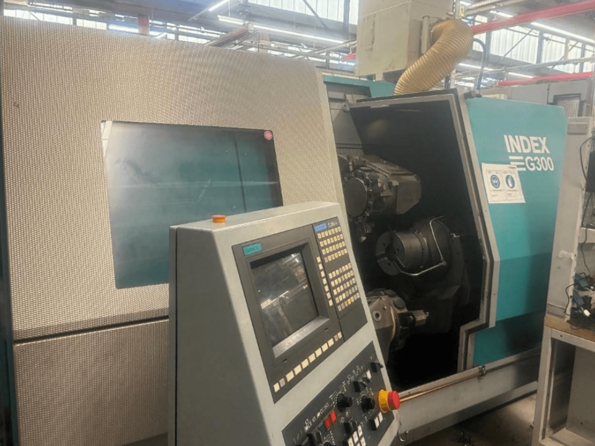 Index G300 horizontal turning machine, front view, showcasing control panel and open access to machinery inside.