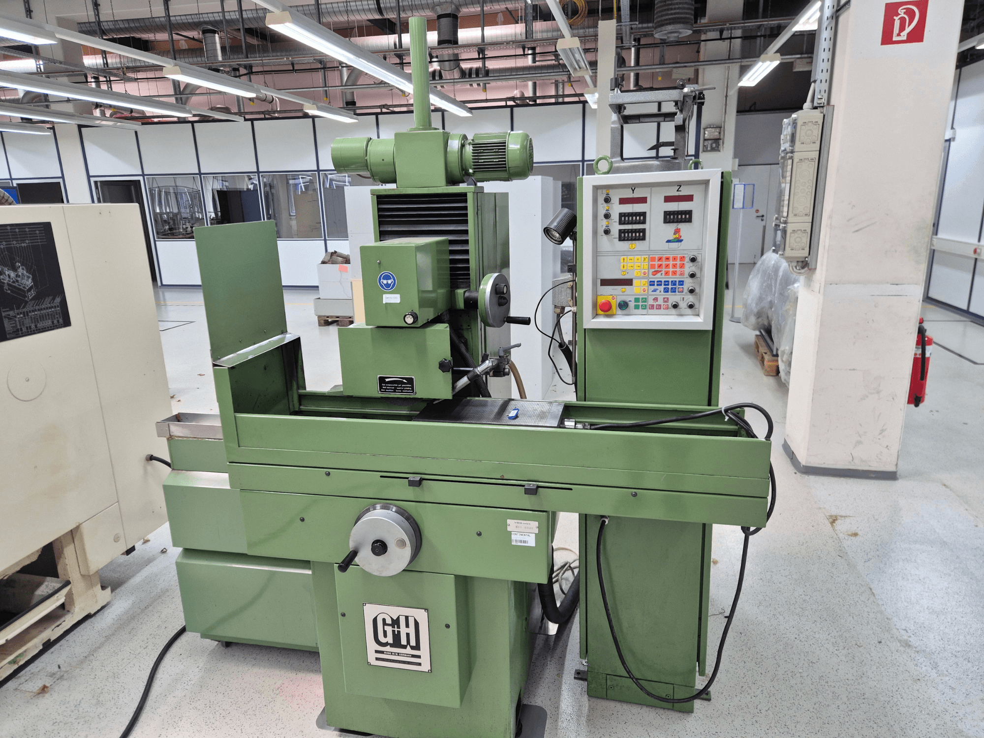 GEIBEL & HOTZ FS 40 SA surface grinding machine in a workshop, showing control panel, grinding table, and motor from a front view.