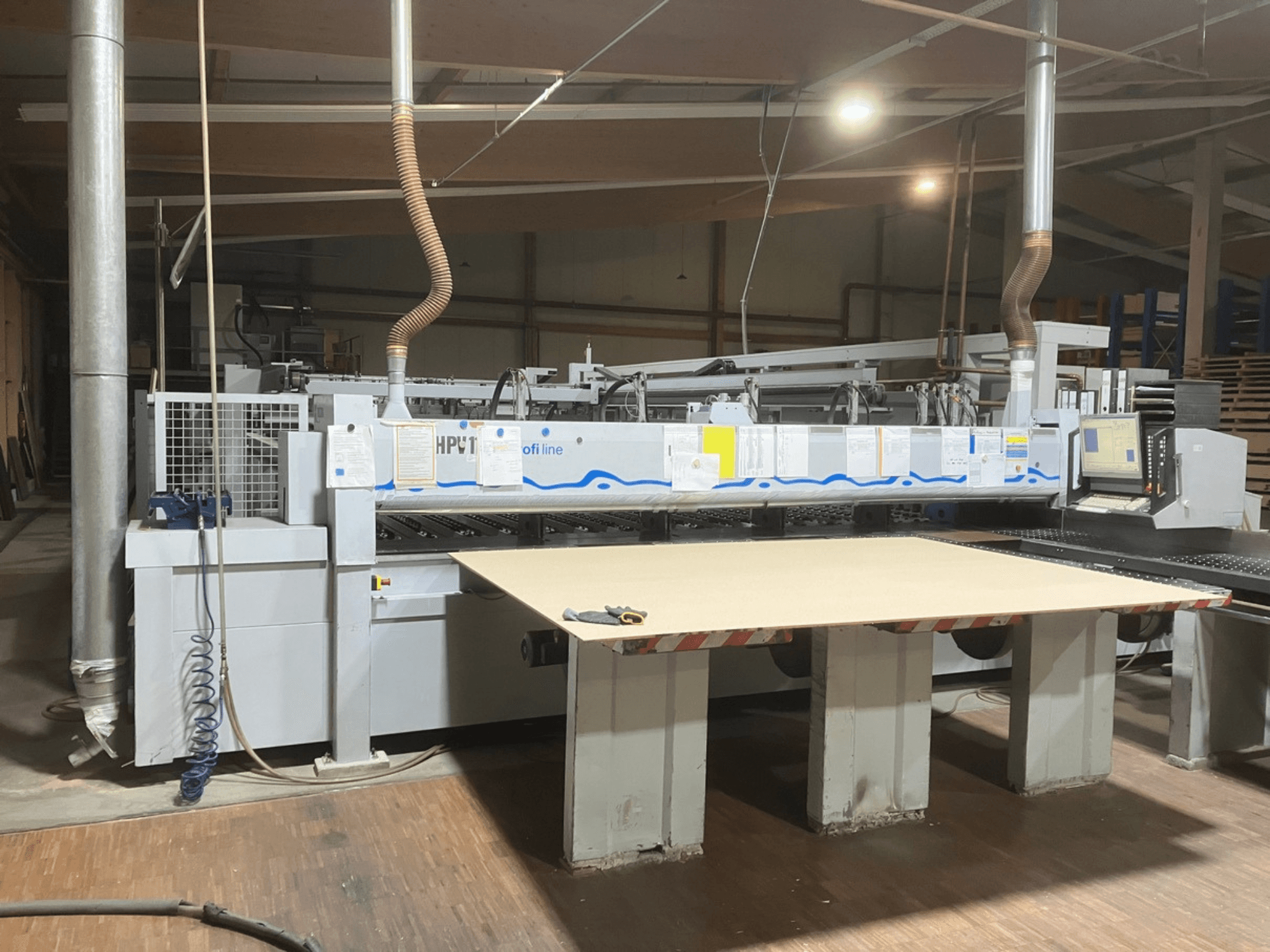 HOLZMA HPV11 panel saw in a workshop, front view with a large, flat work surface and control panel visible.