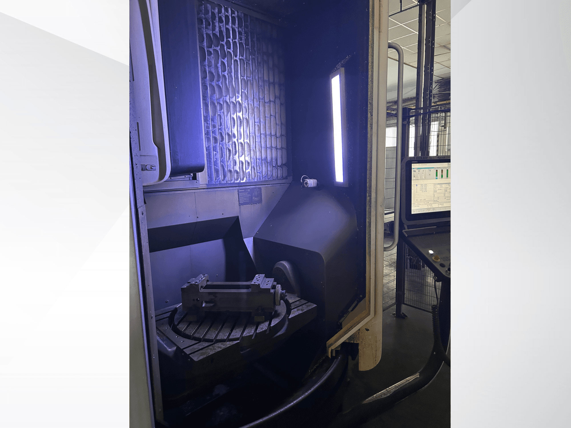 DMG MORI DMU 65 MonoBlock vertical machining center, front view showing rotary table with workpiece and control panel.