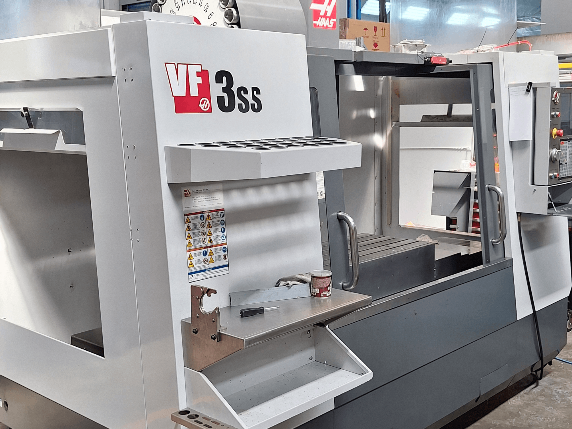 Haas VF-3SS vertical machining center, front view, showcasing control panel, tool holder, and working area.