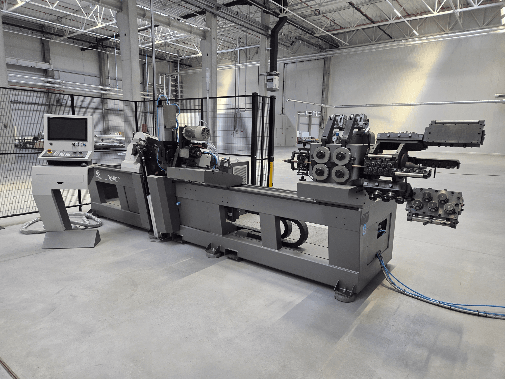 BLM DH4010COC roll bending machine in a factory setting, front view showing control panel and bending rollers.