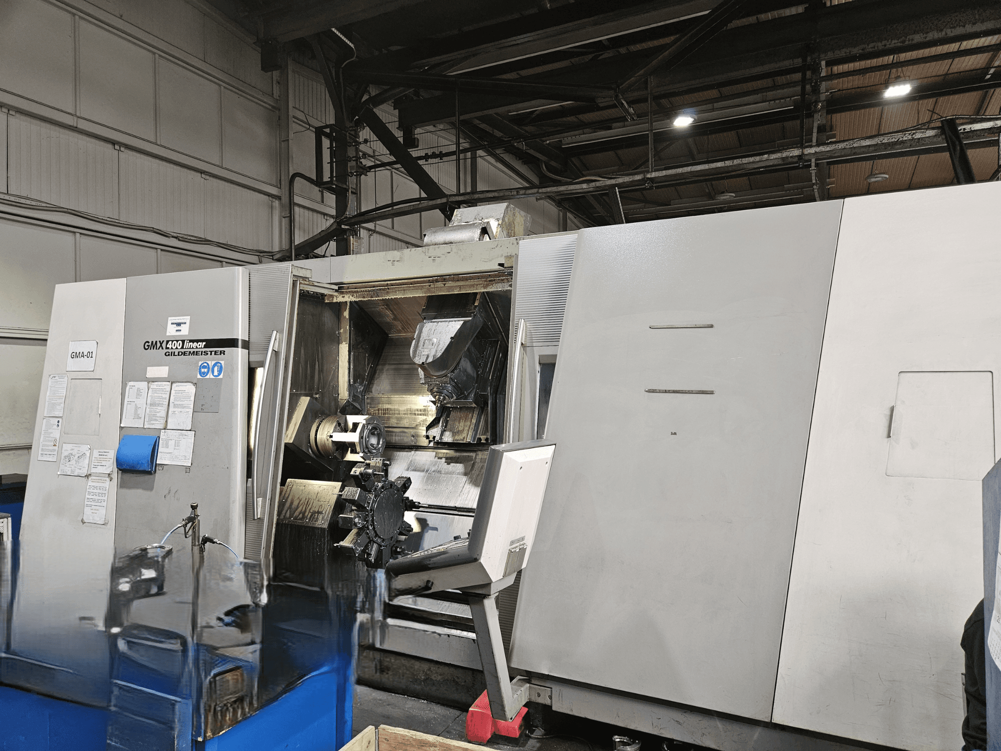 Gildemeister GMX 400 Linear turn-mill centre in front view, showcasing open access to the machining area and tools inside.