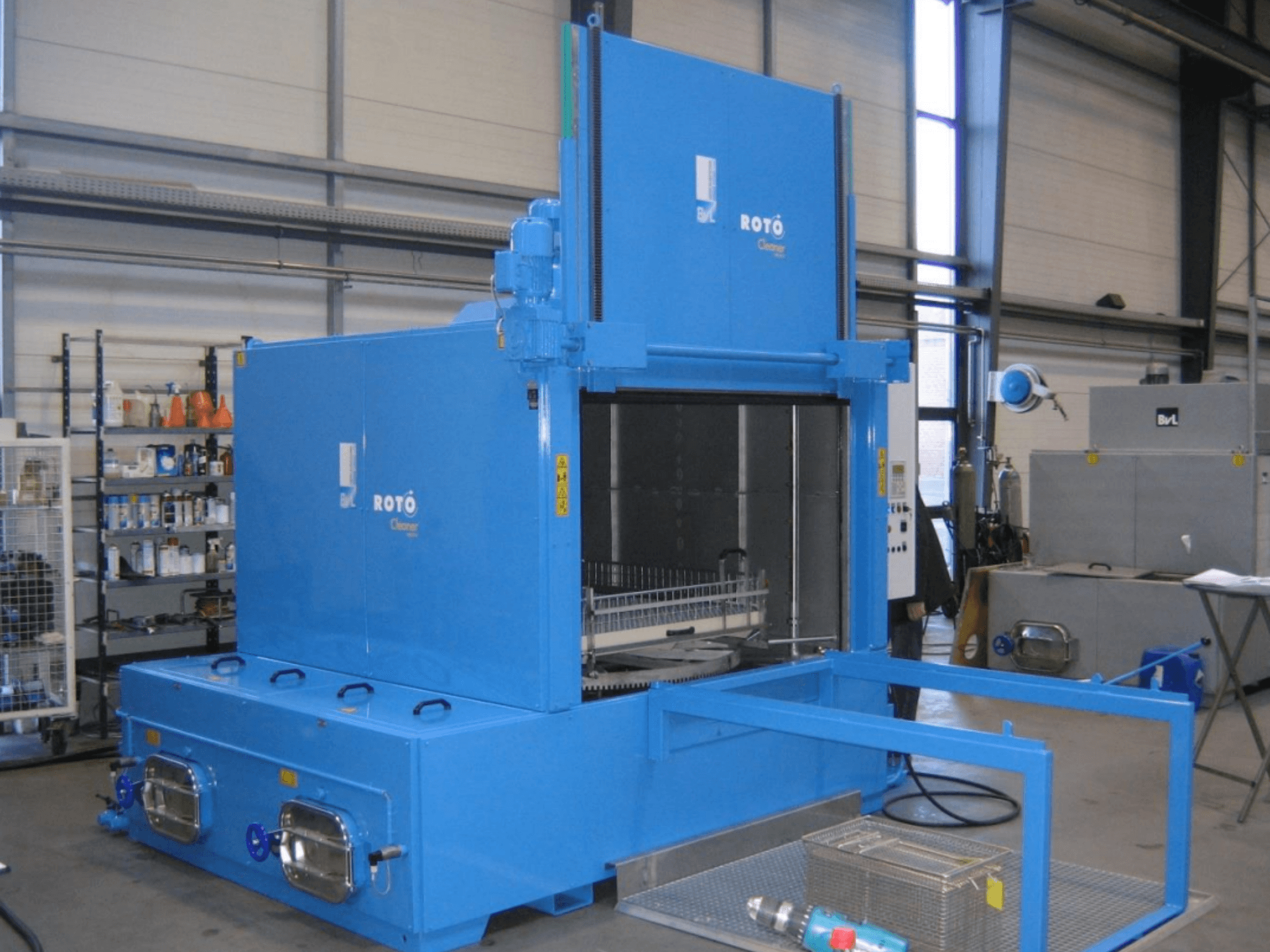 BVL RC 1950 RW 2T machine tool in blue, front view, showcasing the cleaner's entrance and basket for parts.
