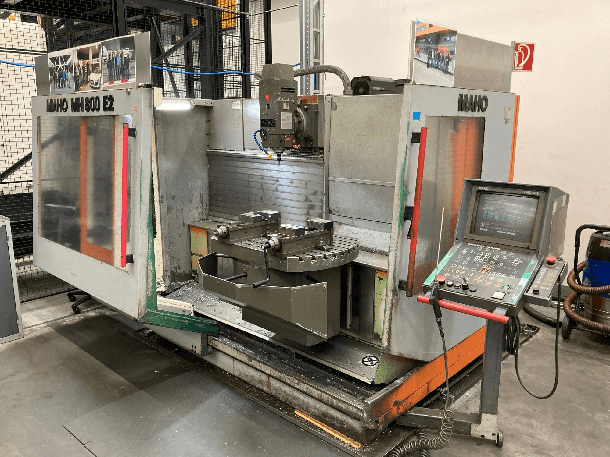 Maho MH 800 E2 CNC milling machine in a front view with control panel, spindle, and worktable visible.
