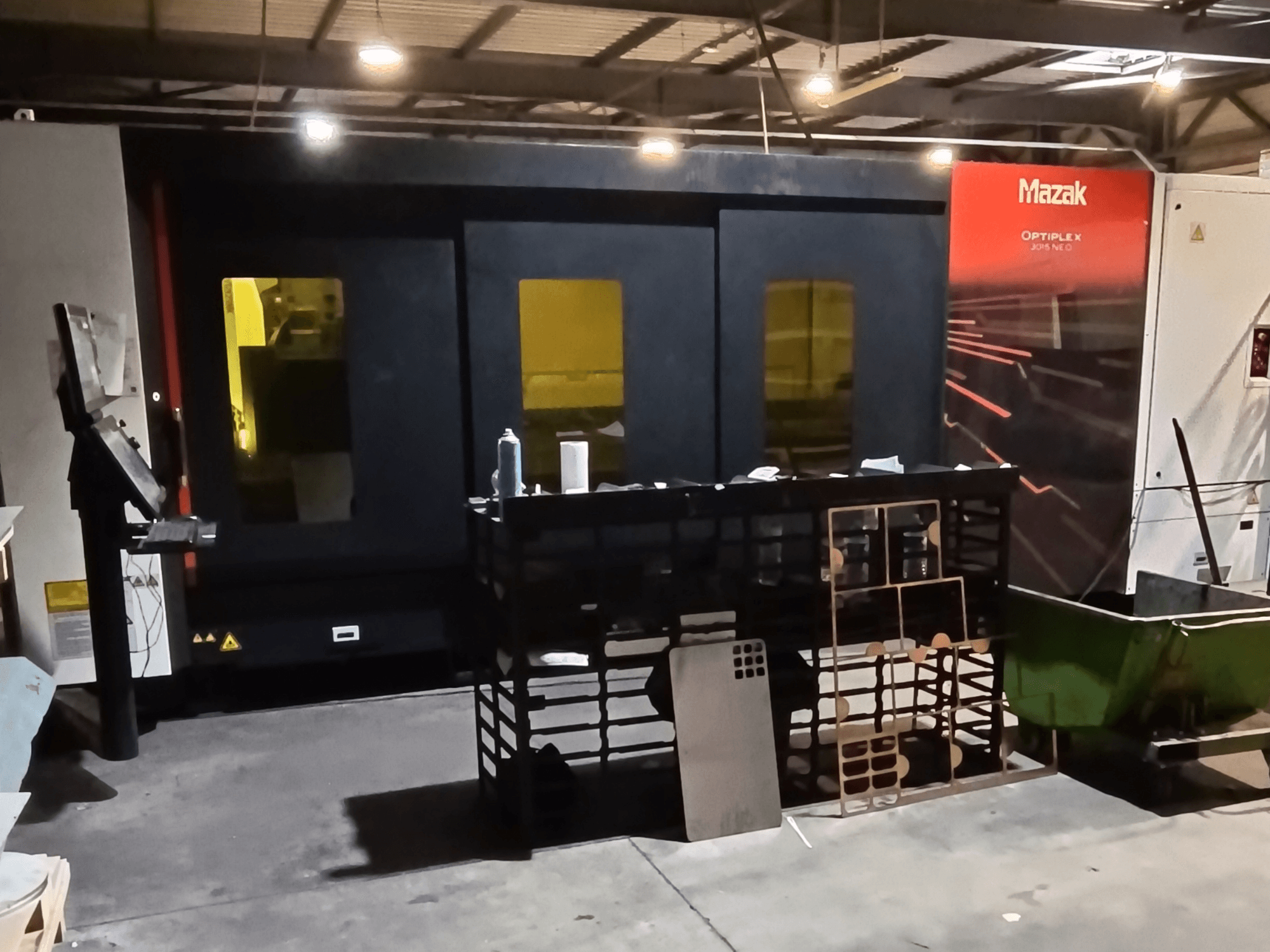 Mazak OPTIPLEX NEO fiber laser cutting machine in a workshop, front view with control panel and processing area visible.