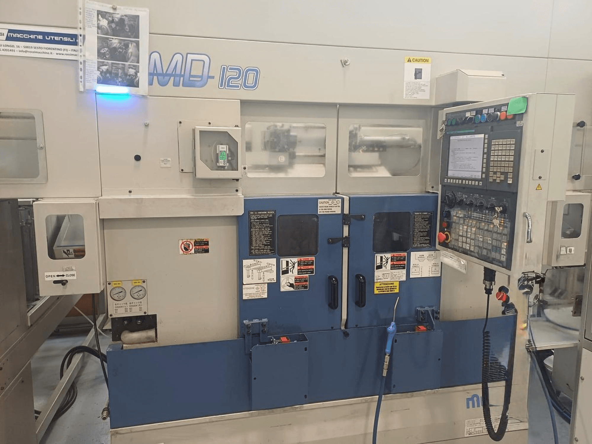 Horizontal turning machine MURATEC MD 120, front view showing control panel, door, and pressure gauges.