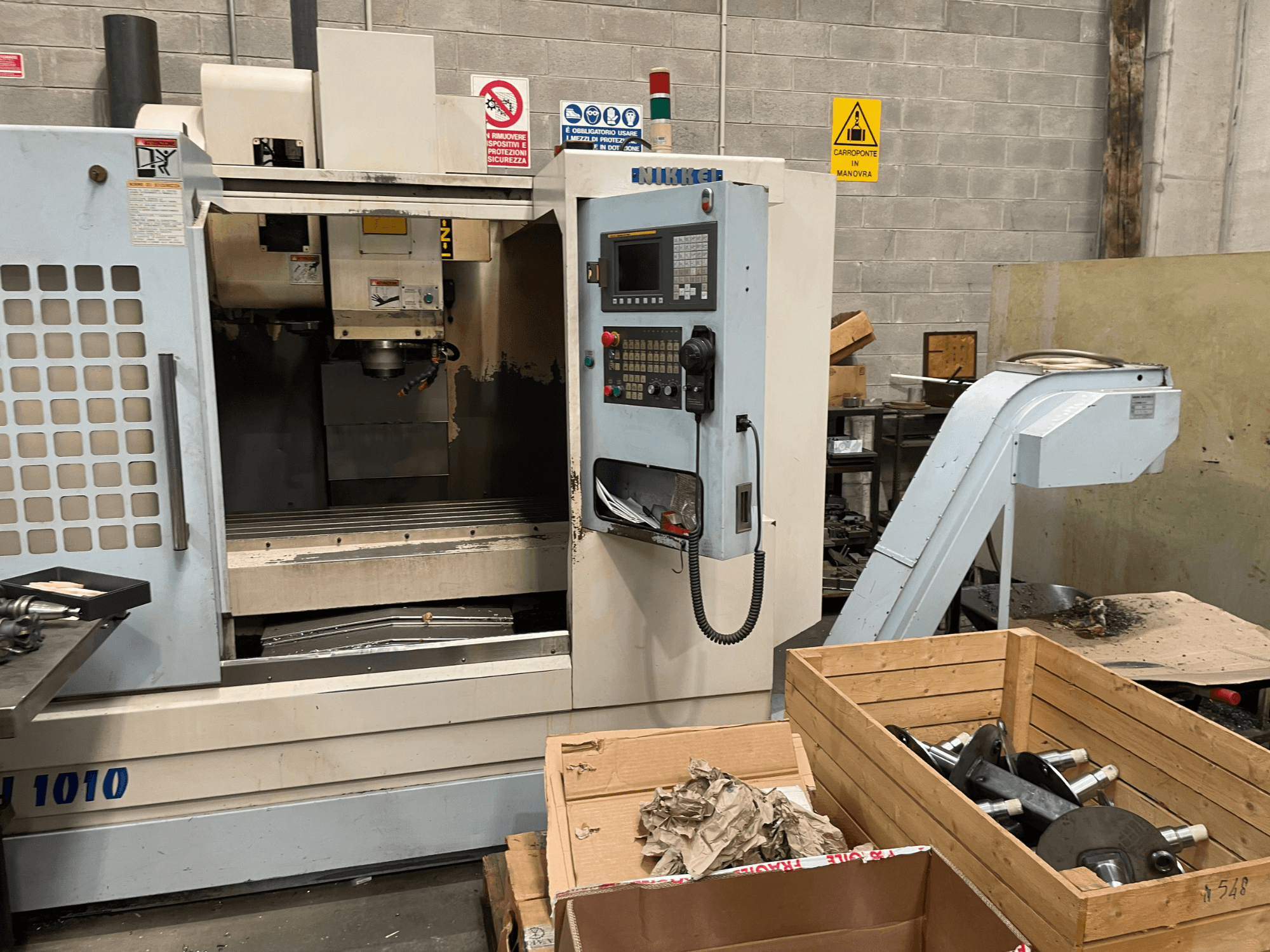 Vertical Machining Centre by Other, model VH-1010, viewed from the front with controls visible and boxes nearby.