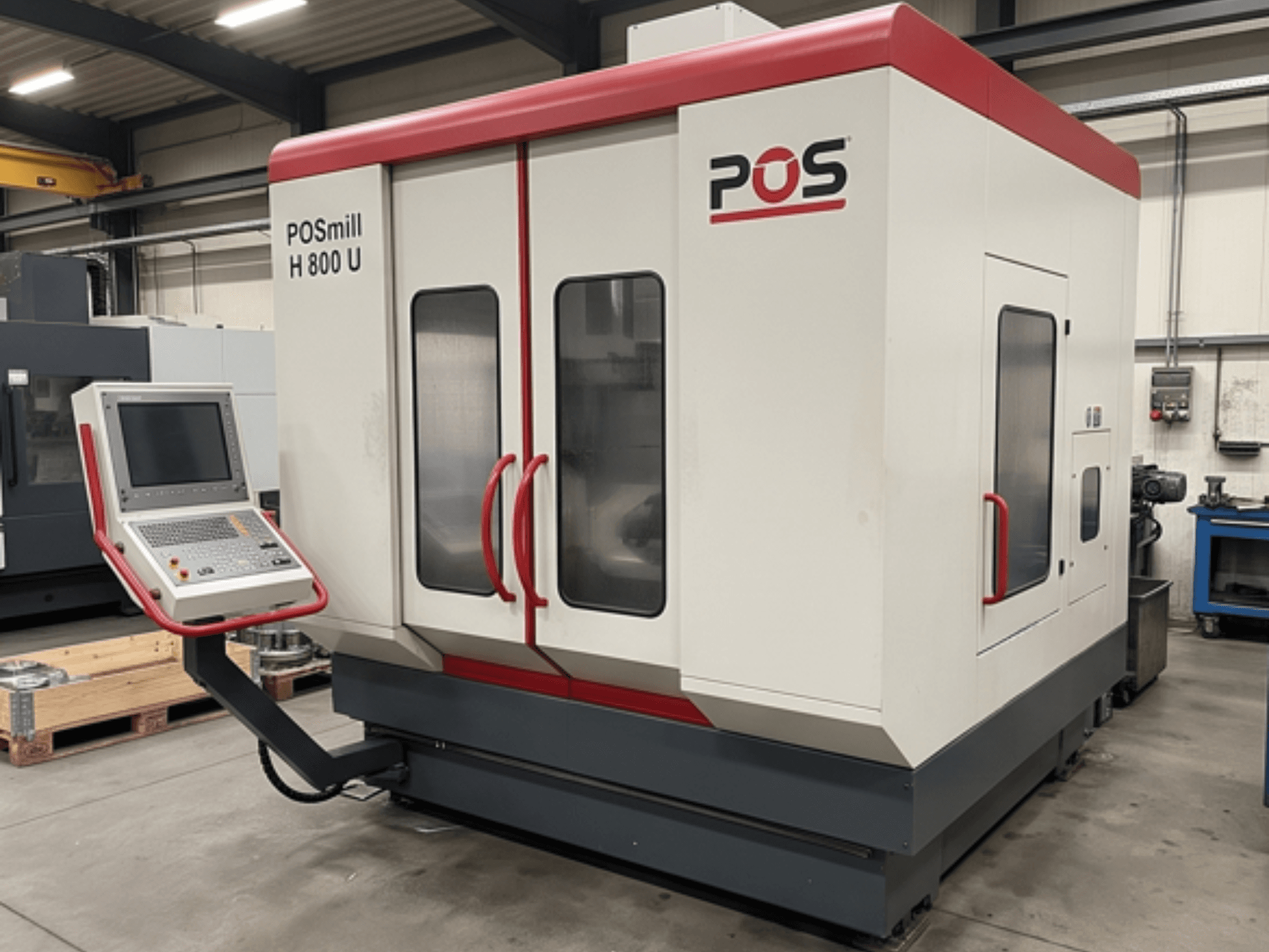 POSmill H800U vertical machining center in a workshop, featuring a control panel and dual glass doors. Side view perspective.