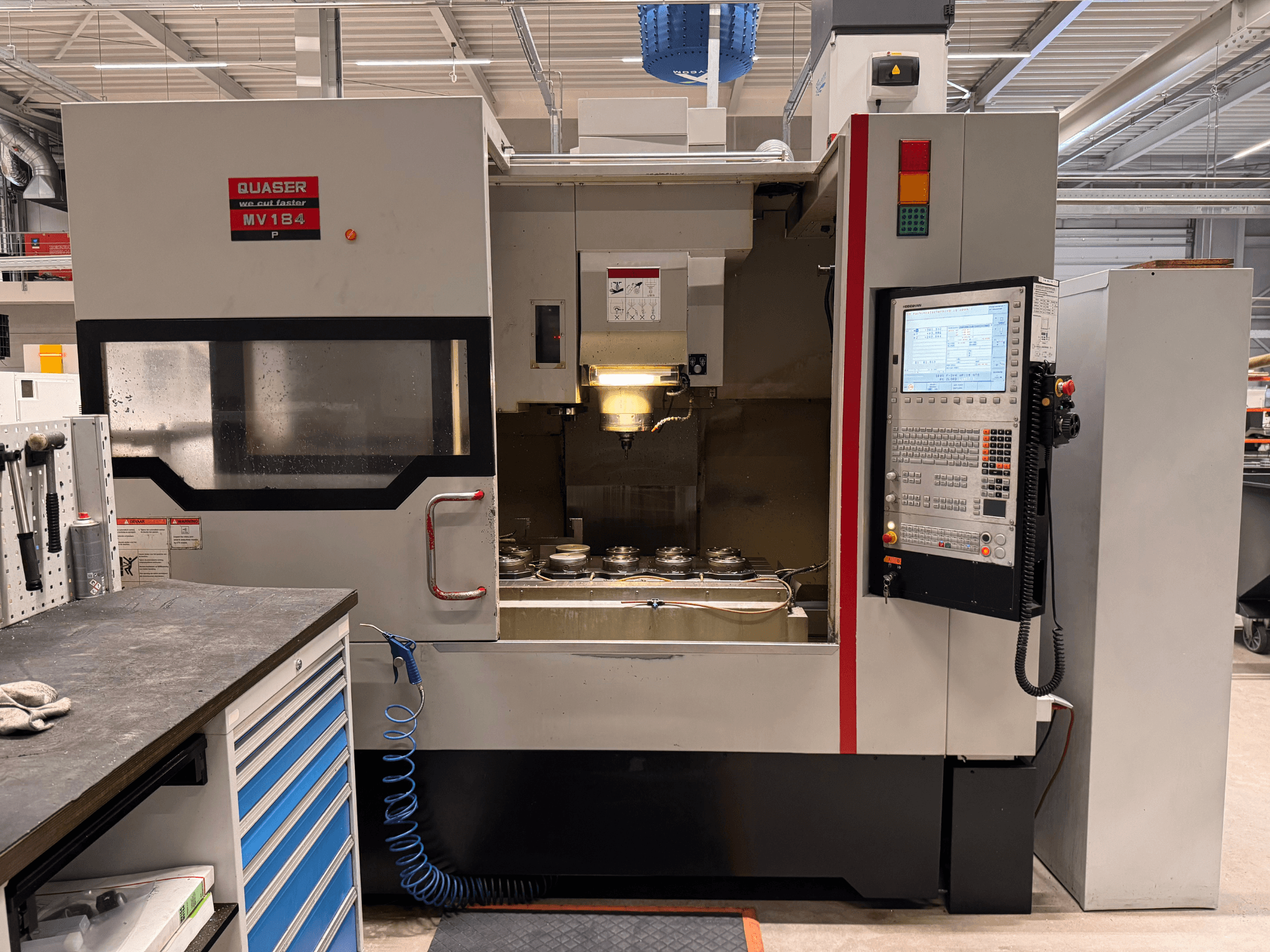 Quaser MV184P vertical machining centre, front view, featuring control panel and tool storage area.