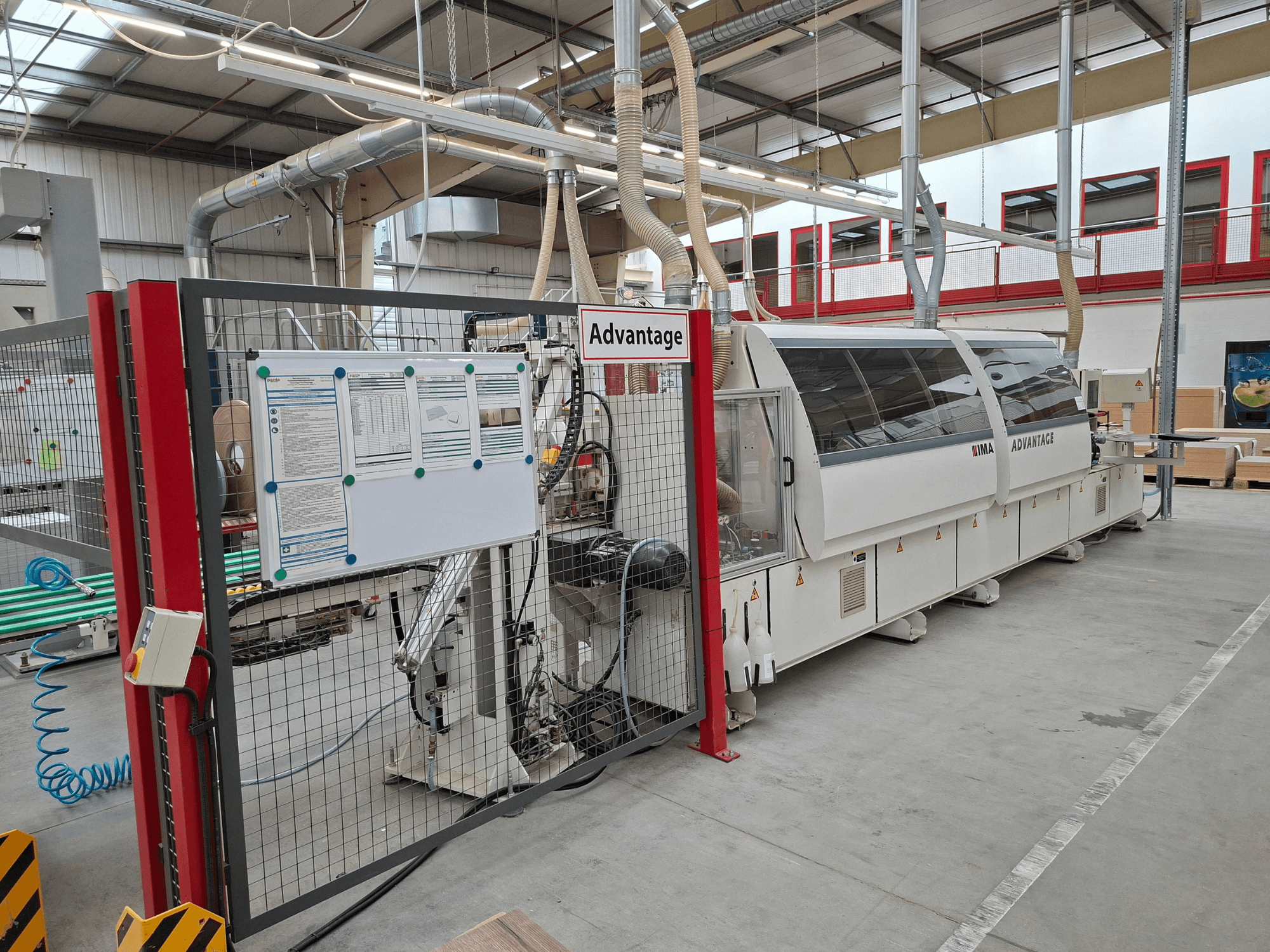 IMA Advantage 600 Edgebander viewed from the front, featuring safety fence and control panel in a workshop setting.