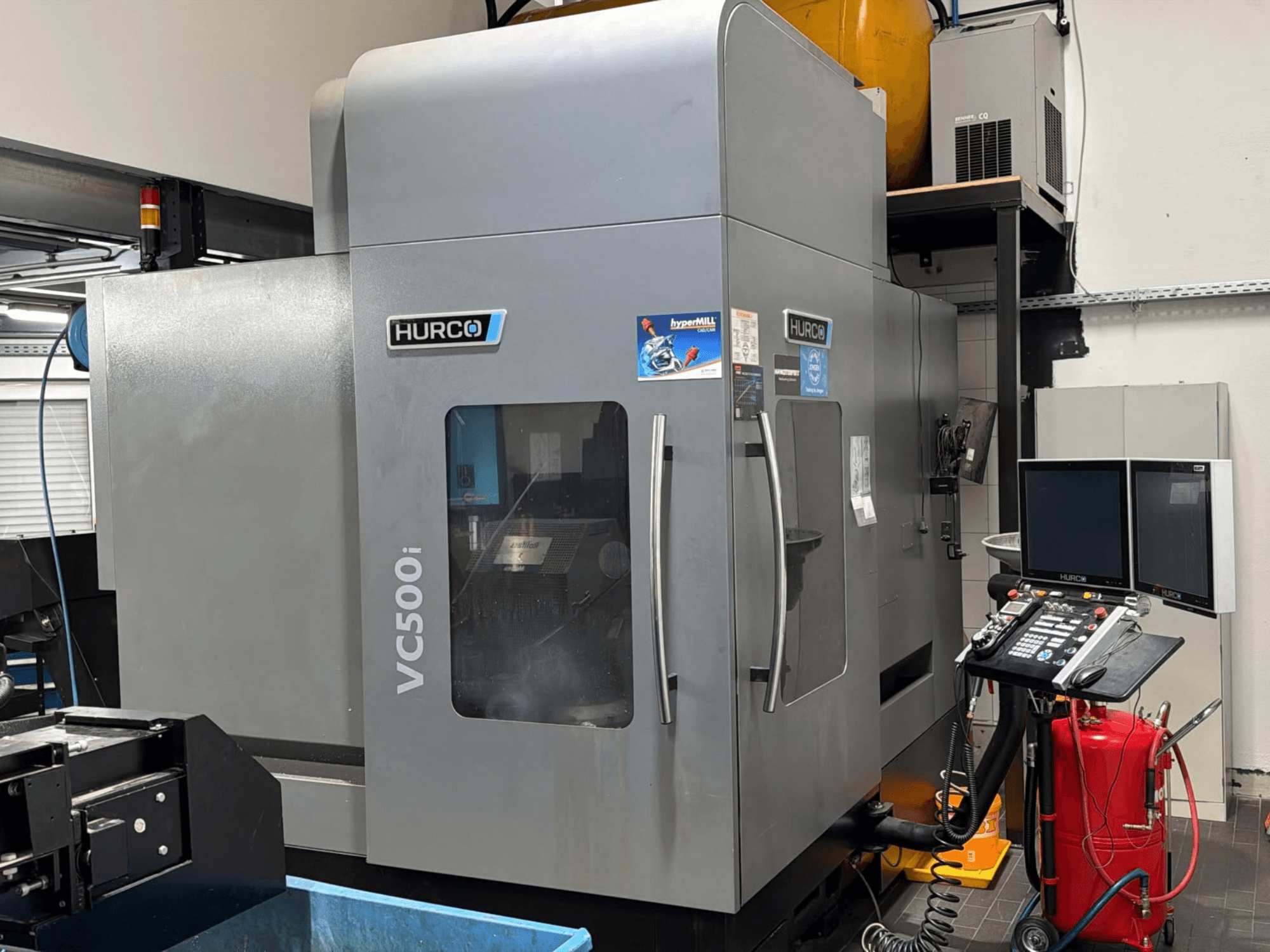 Hurco VC500i vertical machining center, front view showing control panel and two monitors, in a shop environment.