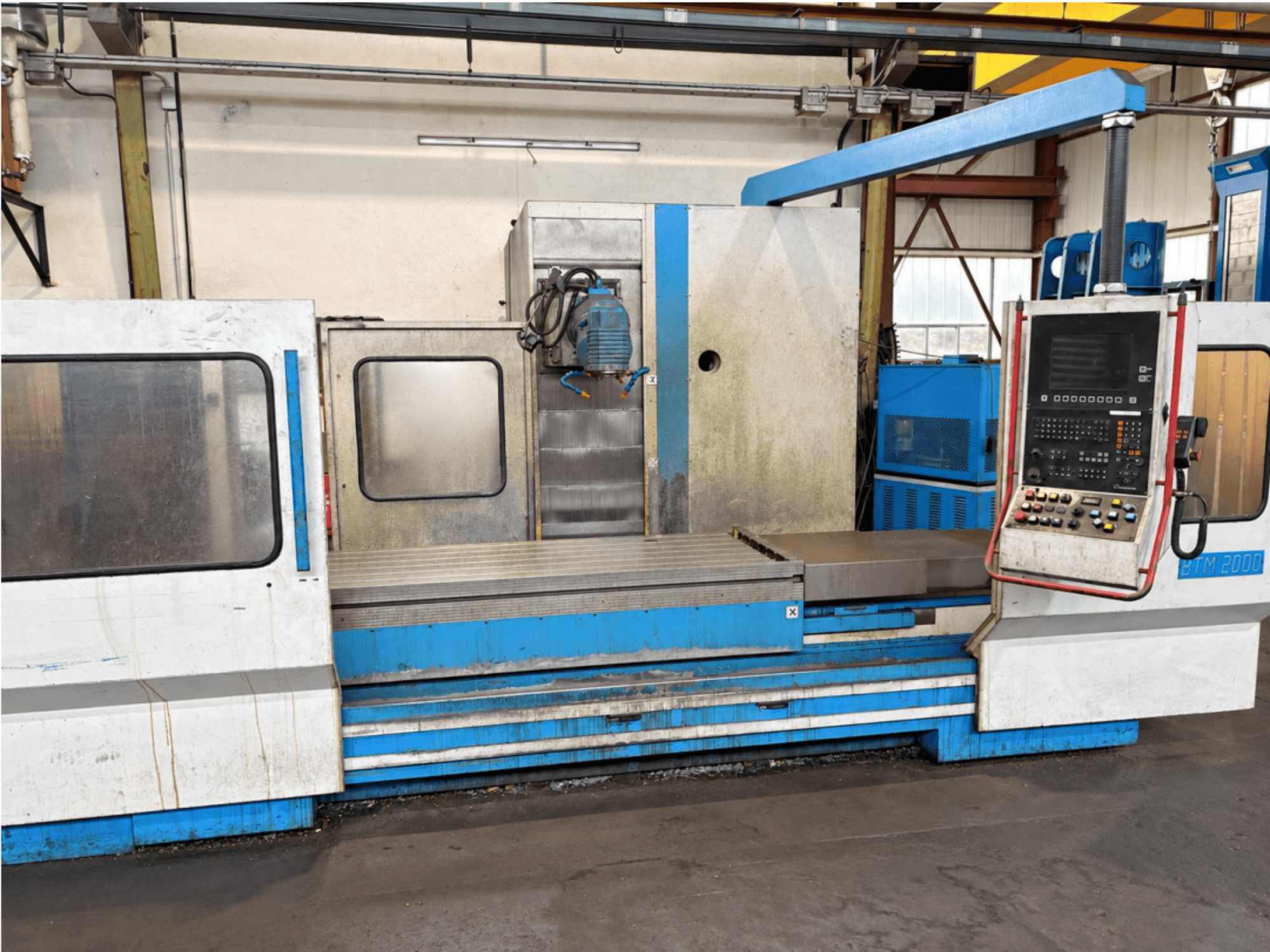 MIKRON BTM 2000 surface grinding machine viewed from the front, showcasing the control panel and grinding table.