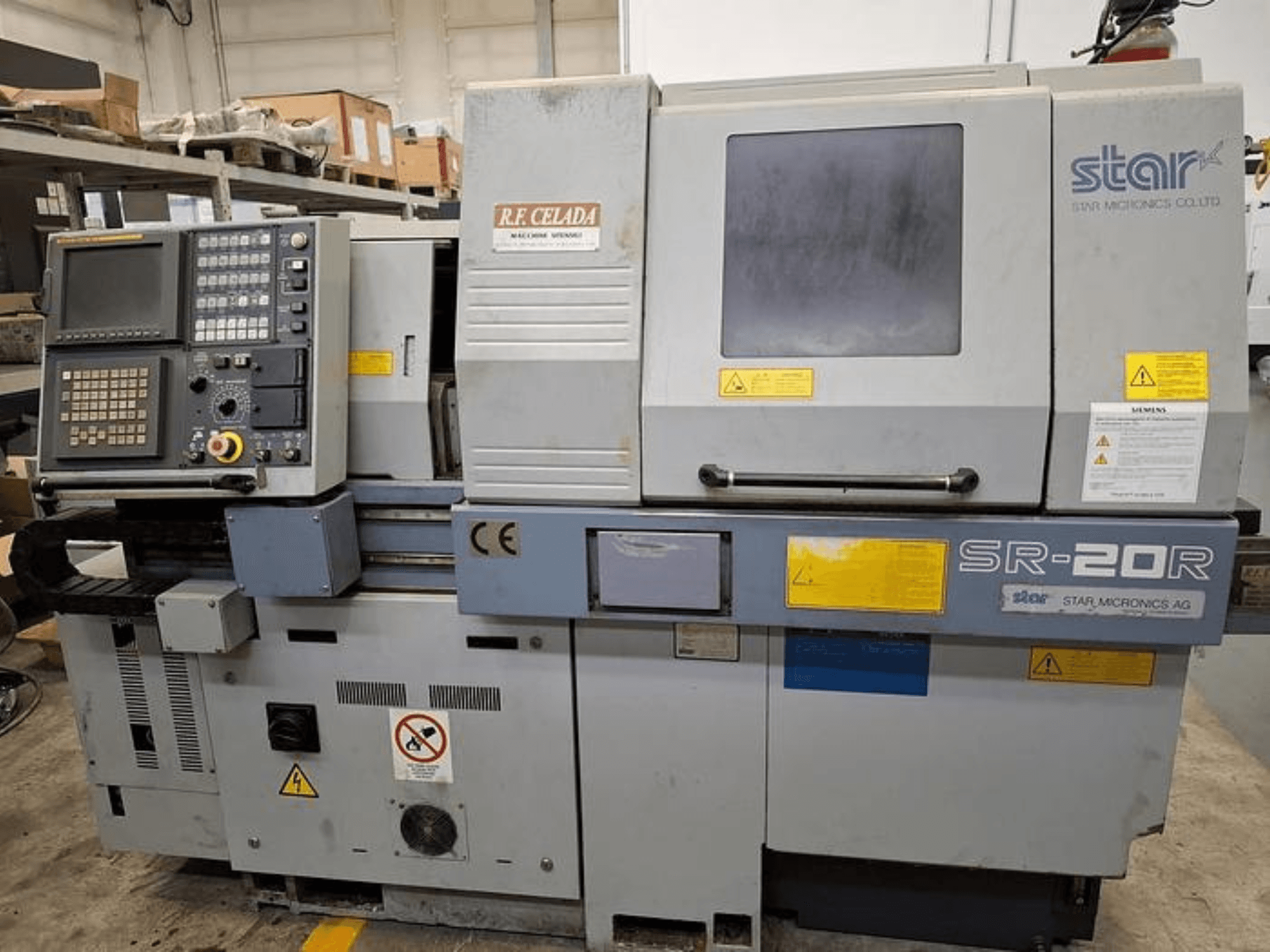 Star SR-20R CNC lathe with control panel, front view, featuring operation buttons, screen, and safety labels.