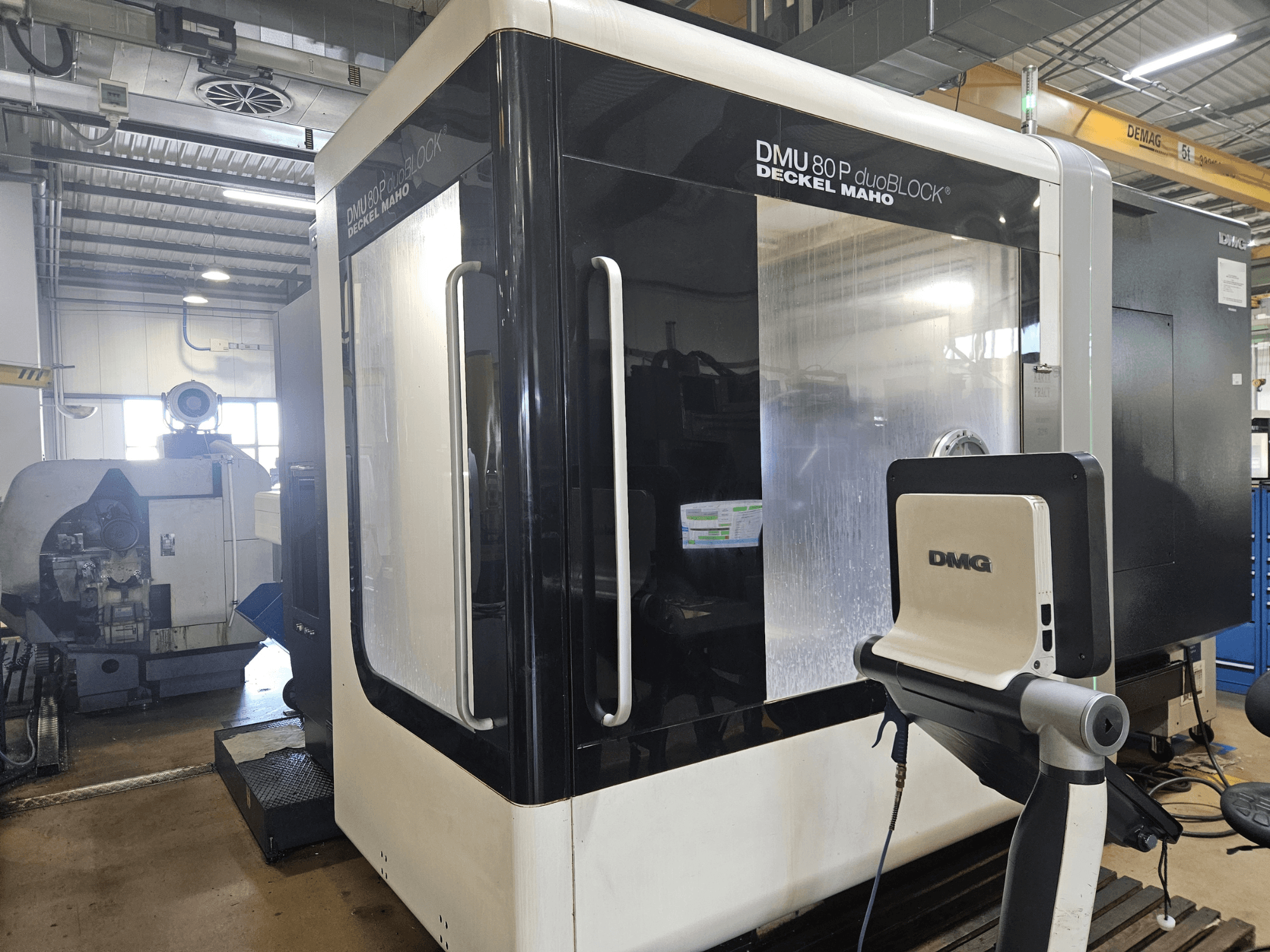 Vertical machining center DMU 80P duoBLOCK by DMG DECKEL MAHO, front view, featuring dual access and control panel in factory setting.