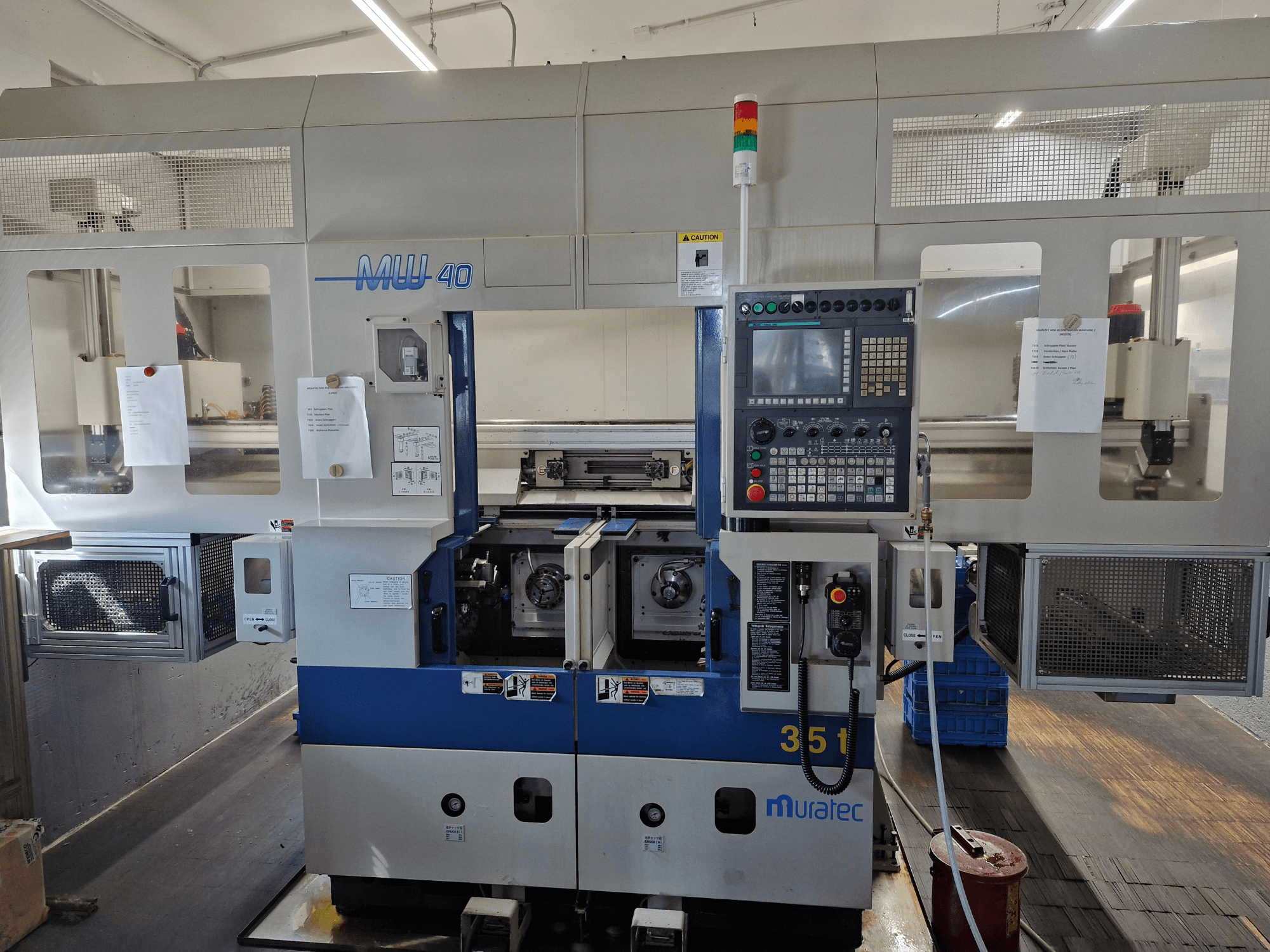 Muratec MW 40 Turn-Mill Centre, front view, showing control panel, tool holders, and operational details.
