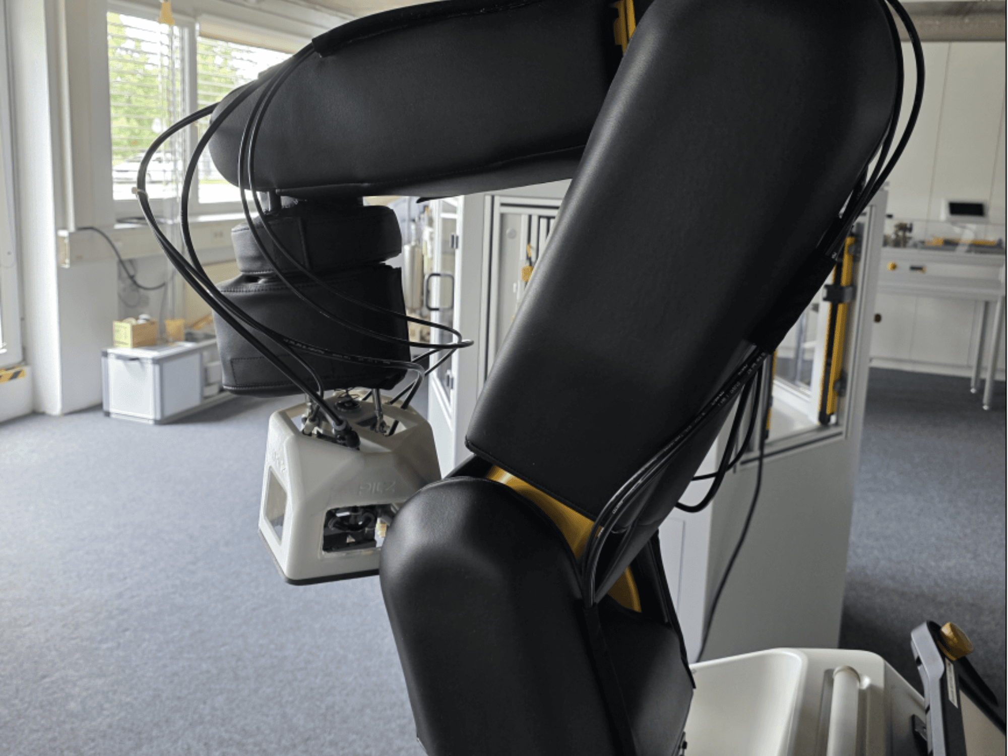 FANUC LR Mate 200iD/7L collaborative robot side view, showing arm and sensors, cables visible in a workshop setting.