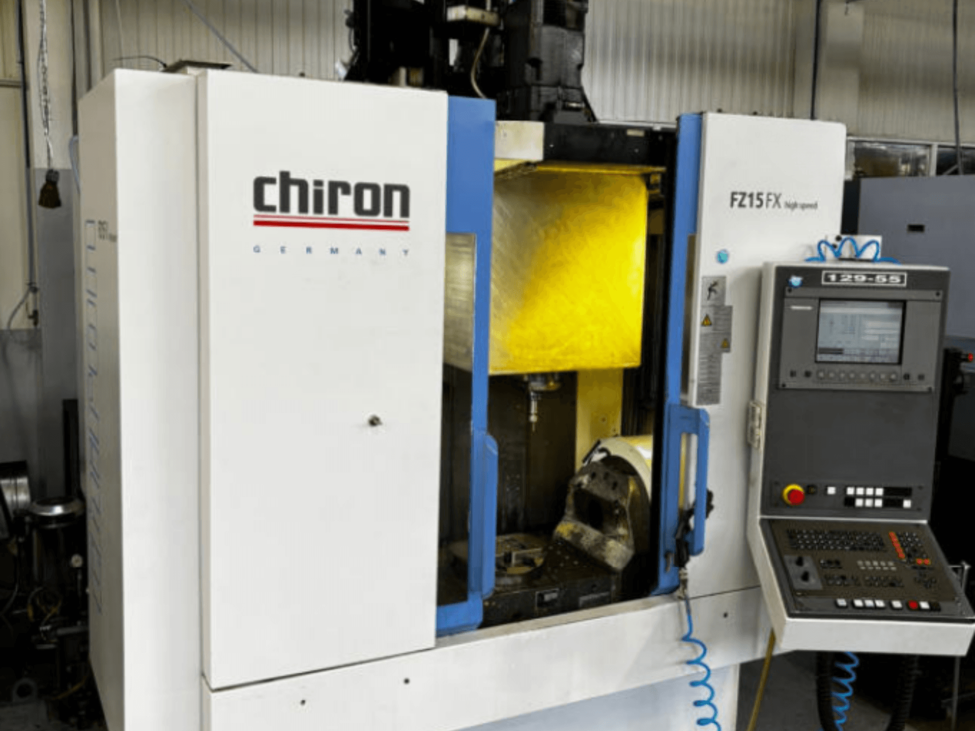 CHIRON FZ 15FX vertical machining centre, front view, featuring control panel and visible machining area with tools.