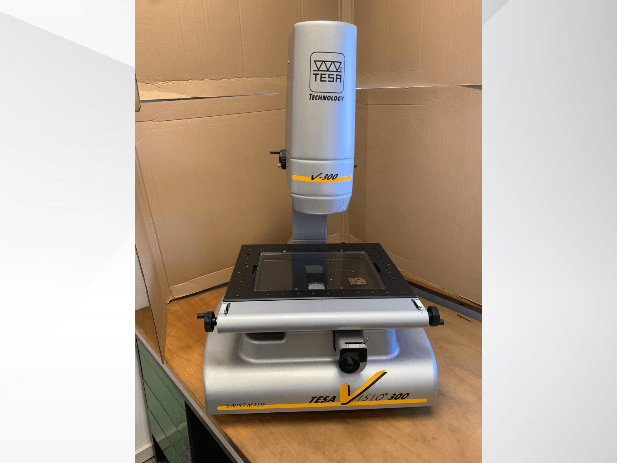 TESA Visio 300 optical measurement machine, front view, features a clear measuring surface and adjustable components. Swiss made.