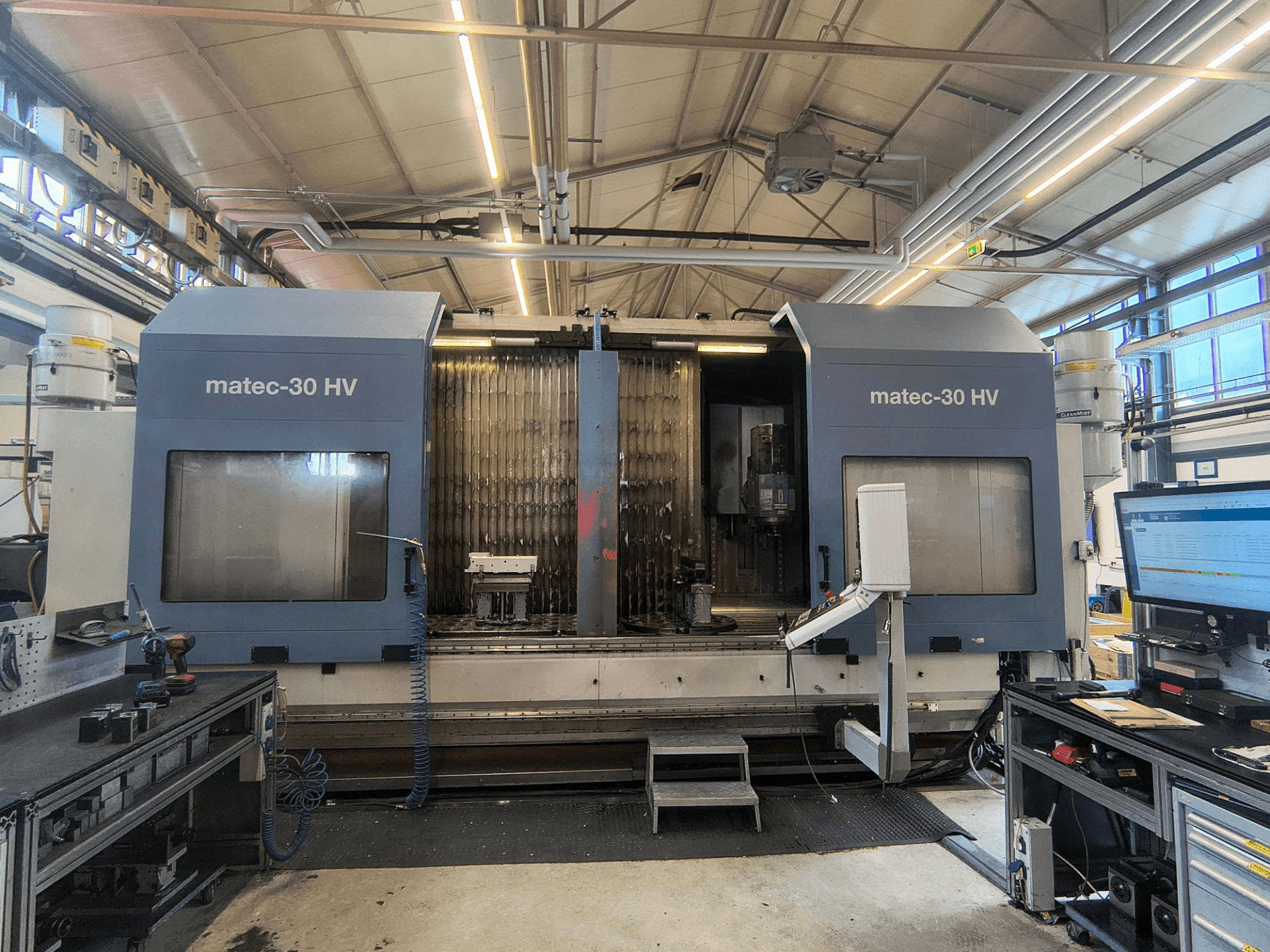 Front view of the Matec 30 HV vertical machining centre, showing control panel, work area, and industrial surroundings.
