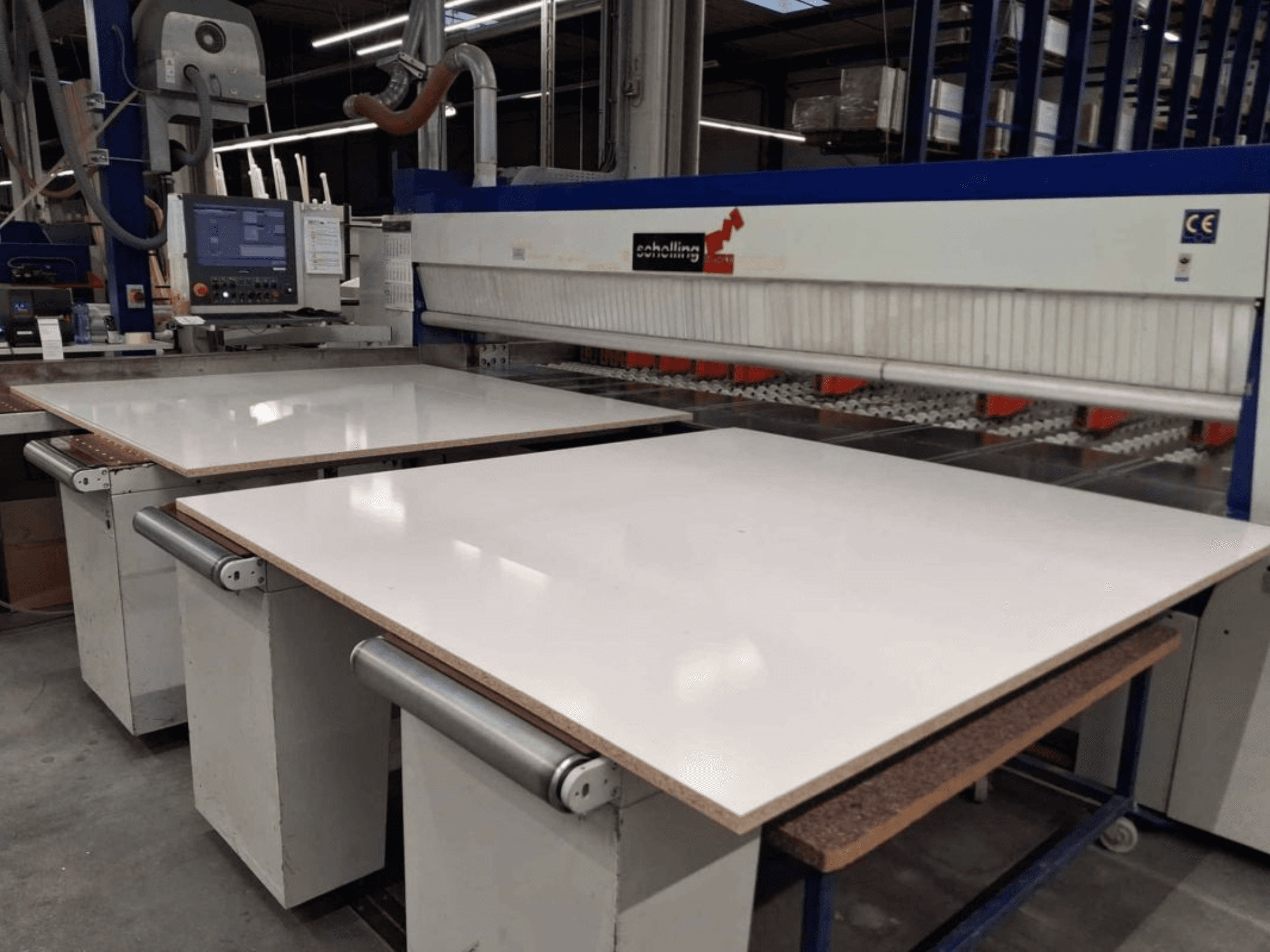 Front view of SCHELLING FM-H 430 panel saw with white cutting table, control panel, and saw blade area visible.