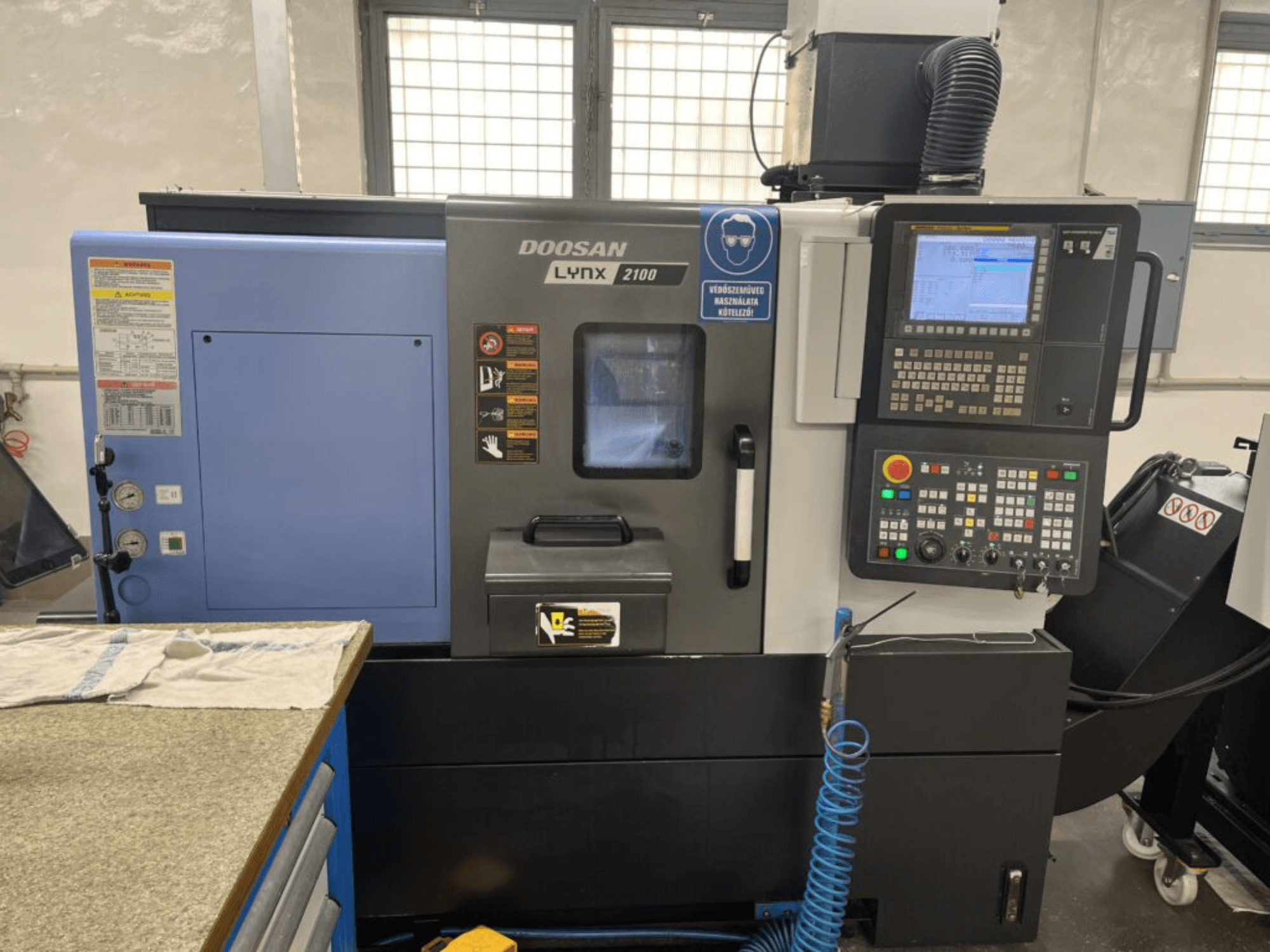 DOOSAN Lynx 2100A horizontal turning machine, front view showcasing control panel, operator interface, and machine features.
