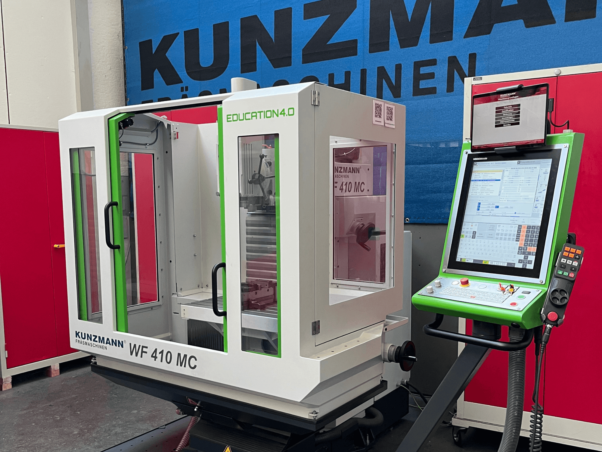 KUNZMANN WF 410 MC universal machining center in front view, showcasing green accents, transparent doors, and control panel.