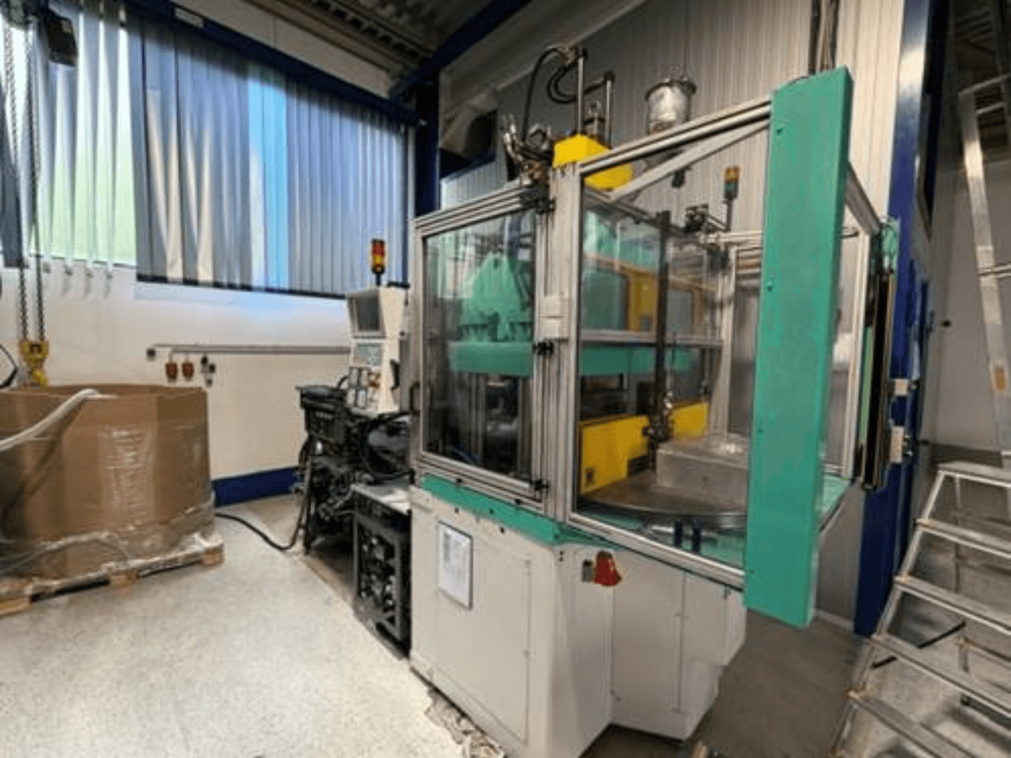 Arburg 1200 TS 800-60-350 vertical injection moulding machine, side view, showcasing control panel and clear safety enclosure.